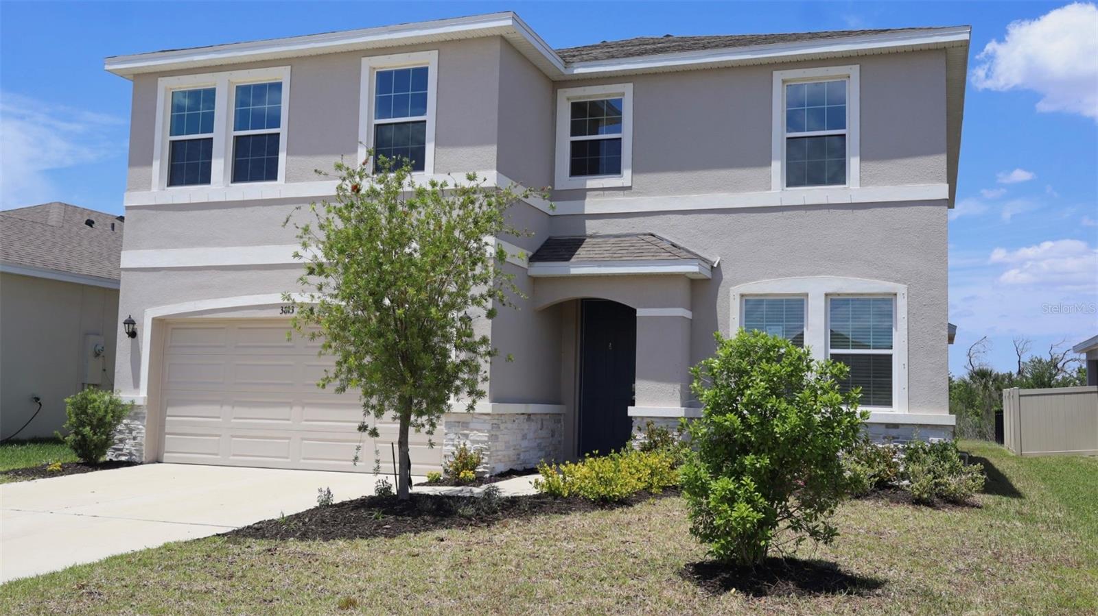 Built in 2022 and impeccably maintained, this like-new home offers 4 bedrooms, 3 full bathrooms, and 2,756 sq ft of thoughtfully designed living space with peaceful preserve views. The open-concept layout showcases a modern kitchen and bathrooms with elegant quartz countertops, high ceilings, and abundant natural light through double-pane windows, along with the added protection of hurricane shutters. A guest bedroom and full bath on the main floor provide flexibility, while upstairs features the remaining bedrooms and an expansive bonus/flex room ideal for a media space, office, or playroom. The first floor is finished with durable ceramic tile, with plush carpeting upstairs for comfort. Step outside to a covered patio overlooking a spacious backyard that backs to a private preserve, with the Braden River beyond—perfect for relaxing or entertaining. Located in the gated Evergreen community, residents enjoy access to a pool and clubhouse, all within a convenient and desirable setting.
