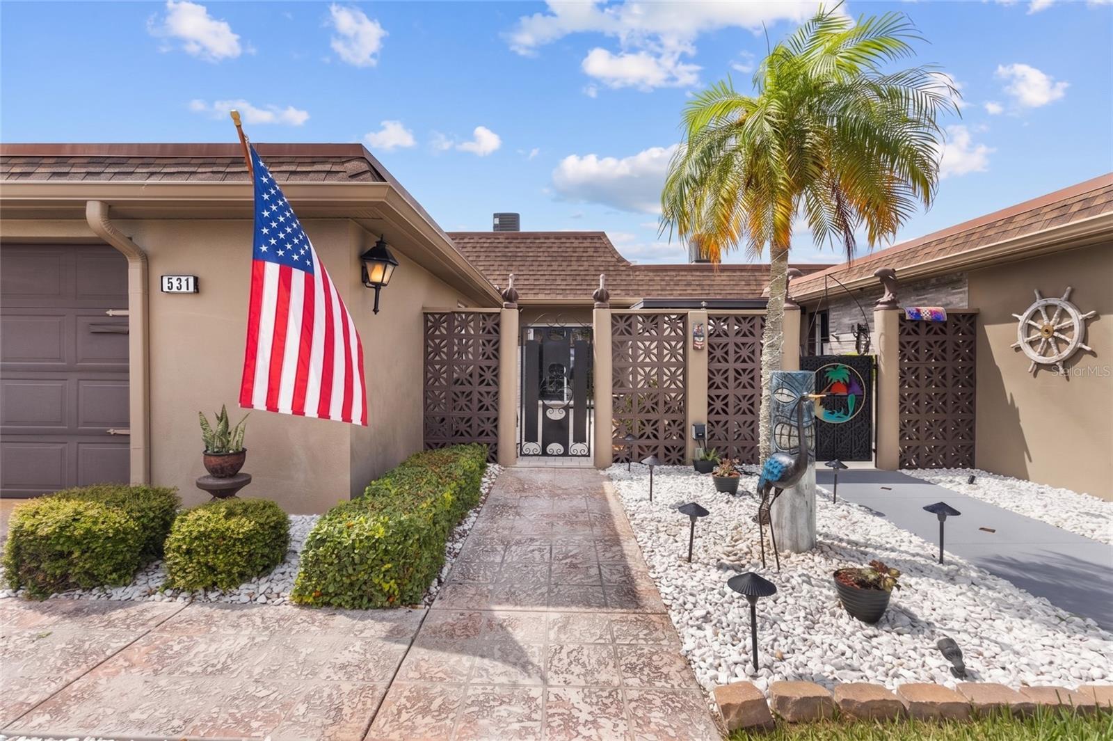 Nestled in one of St. Petersburg's premier GATED 55+ WATERFRONT BOATING COMMUNITIES, this exquisitely renovated coastal villa offers the perfect blend of luxury, comfort, & carefree living. Wake up each morning to peaceful water views, sip your coffee as dolphins & manatees glide by, spend the afternoon cruising the intracoastal waterway, and end your day watching spectacular sunsets! Designed for water lovers, this beautifully updated home offers 1,640 SQUARE FEET of thoughtfully designed living space, complete with a PRIVATE COMPOSITE DOCK & 9,000 LB BOAT LIFT giving you direct access to the Intracoastal Waterway & the Gulf. Whether you're heading out for a day of fishing, docking at a waterfront restaurant, exploring nearby islands, or simply enjoying an evening cruise, your next adventure begins just steps from your back door. Inside, nearly every inch of the home has been transformed during an EXTENSIVE 2025/26 RENOVATION that blends timeless coastal elegance with today's modern conveniences. Sunlight pours through expansive sliding glass doors, filling the open-concept living spaces, drawing your eyes to the beautiful canal views. The PRIMARY SUITE offers a truly special retreat, allowing you to wake each morning to serene water views before you even step out of bed! The SPACIOUS ENCLOSED FLORIDA ROOM is the perfect place to entertain guests, unwind with a favorite book, or simply watch boats drift by. At the heart of the home is the stunning designer kitchen, featuring BRAND NEW STAINLESS STEEL APPLIANCES along with beautiful UPPER & LOWER SOFT-CLOSE KITCHEN CABINETS & GRANITE COUNTERTOPS. The seamless flow into the wide-open dining & living areas creates an inviting space for entertaining family & friends. Beyond its beautiful finishes, this home offers something every buyer will appreciate - PEACE OF MIND. The renovation includes a NEW ROOF, ELECTRICAL PANEL, & ELECTRICAL RECEPTACLES & SWITCHES throughout, & BEAUTIFUL NEW FRONT ENTRY DOOR and all new window dressings. The A/C SYSTEM WAS REPLACED IN 2023 with FLEX VENTING added in the attic in 2025. Every improvement was PROFESSIONALLY DONE, PERMITTED, INSPECTED, & FULLY CLOSED OUT, allowing you to move in with confidence knowing the major work has already been completed. The seller also invested in exceptional long-term value! The $30,000 ROOF ASSESSMENT HAS ALREADY BEEN PAID IN FULL, saving the next owner a significant expense. Following the 2024 Hurricanes, the seller invested an additional $30,000 to install a FULL-HOME GARRISON FLOOD BARRIER SYSTEM, providing one of the industry's leading flood mitigation solutions & an added layer of protection & peace of mind during Florida's storm season. Life at Boca Ciega Point is about embracing an active, social Florida lifestyle with TWO CLUBHOUSES, HEATED POOL, PICKLEBALL, TENNIS, BOATING CLUB, AND YEAR-ROUND SOCIAL EVENTS. The association fee includes FLOOD INSURANCE, WATER, SEWER, TRASH, EXTERIOR MAINTENANCE, LAWN CARE, INTERNET & CABLE, making this the perfect lock-and-leave home for snowbirds. Head north for the summer if you choose, then return to enjoy the lifestyle you've earned. Just 5 MINUTES FROM MADEIRA BEACH, JOHN'S PASS, GULF BEACHES, WATERFRONT DINING, SHOPPING, AND ENTERTAINMENT, this is more than a waterfront villa—it's your invitation to live the Florida lifestyle you've always imagined.