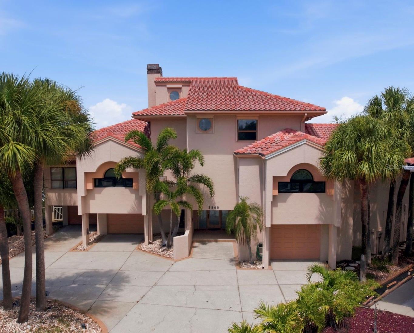 This magnificent estate is set on an exceptional location and lot with 102 ft frontage a wide open billion-dollar view of BOCA CIEGA BAY and yearlong 180-degree SUNSET views this estate masterpiece spans over 4155 sq ft of refined interior living space. A dramatic open-concept three story which wraps around the living area with a commanding fireplace that anchors the soaring cathedral ceilings. The sweeping water views from each room on the second level is where you can capture synchronized sunset views and compliments with large balconies and outdoor cook top and refrigerator for entertaining. The high caliber of kitchen appliances alongside elongated island provides exceptional versatility for entertaining as well as two resort-type bars. Outside the home transforms into a private oasis with spa and resort-type sparkling pool full 180 degrees of water views. The pool bathroom has washer and dryer hook-ups, shower, vanity, and benches.  The wood deck spans most of the property. Additional highlights include Primary Bedroom with ensuite and Hugh walk-in closet, two additional bedrooms also ensuite and a loft. The three garages has parking for 4 vehicles. Quality high grade superior structural elements built this custom masterpiece in 1990 with many extras. Hurricane Shutters, Central Vacuum, Elevator, pet bathtub are just a few. The famous Vaughn McCarthy & Sons of PVC architects designed it and a full set of blueprints are available.  PASADENA YACHT AND COUNTRY CLUB is one of the finest country club communities on the west coast of Florida. Enter through the 24/7 Guard Gate to a refined lifestyle full of pastoral land and mature landscapes. PASADENA YACHT CLUB AND COUNTRY CLUB is a very sought after community and this masterpiece is offered for the first time. Come and enjoy the ultimate in Florida lifestyle.