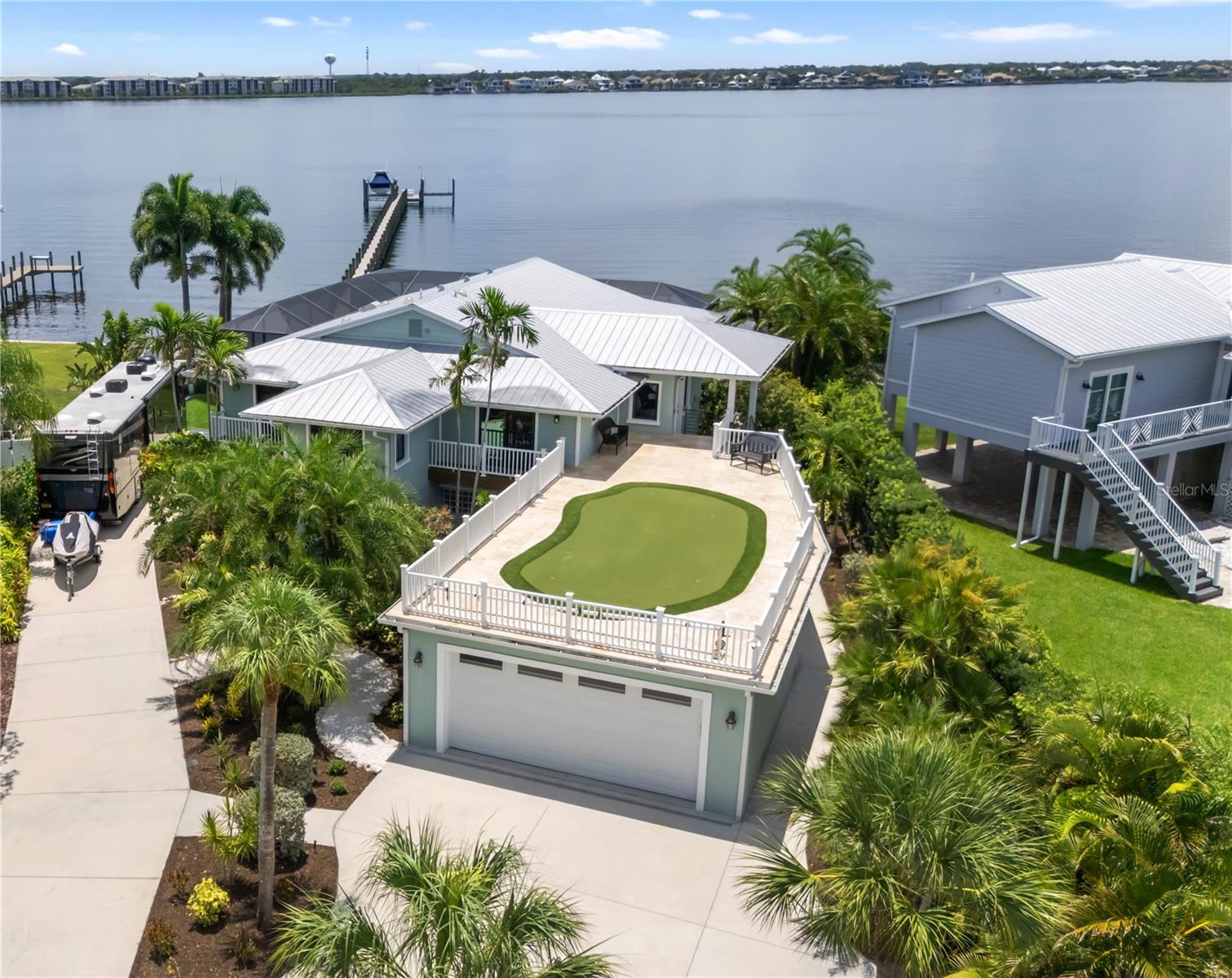 Virtually Staged. STUNNING WATER VIEWS AND QUICK GULF ACCESS! Crafted for the Discerning Boater and Luxury Waterfront Buyer, this 5-bed, 3.5-bath Manatee River Masterpiece with Flex Room, Double Den, Oversized 3+ car Garage, and approximately 4,282 heated sq ft offers an Elevated Coastal Lifestyle with Direct Access to the Gulf. From Sunrise on the River to Blazing Sunset Skies from the Rooftop Putting Green, every inch of this residence is designed to maximize the Views and the Waterfront Experience.

Ride the ELEVATOR up to A Dramatic 750 sq ft Great Room with Floor-to-Ceiling High-Impact Windows showcases Sweeping, Wide-open River Vistas that feel like living on the Bow of a Yacht. The Gourmet Upstairs Kitchen features Professional-grade Appliances, Soft Close Cabinets, a Custom Granite Breakfast Bar that seats 8, Corner Fireplace, Entertainment Center, Vaulted Ceilings, and a Stylish Dining Area—Perfect for Hosting Sophisticated Dinner Parties or Relaxed evenings overlooking the Water. Two Luxurious Master Suites each offer Private Balconies, Designer Baths, Elevated Finishes, and Full Motorized Window Shades, creating true Hotel-Caliber Retreats with Effortless Control over Light, Views, and Privacy. A 1,600 sq ft Rooftop Putting Green with Panoramic Sunset and Canal Views adds a Unique Resort-style Amenity rarely found in single-family Waterfront Homes.
The Thoughtfully Renovated lower level provides incredible flexibility for High-end Buyers who Value Space and Options—featuring a 2nd Full Kitchen, Newly Updated Bathroom, and New Interior and Exterior Doors and Casings, ideal for Visiting Guests, Multigenerational Living, Staff Quarters, or a Quiet Executive Workspace. New AC systems installed in December 2024 with "Second Wind" UV bulbs deliver Advanced Antimicrobial, Anti-Fungal, and Antiviral Sterilization to the Air Circulation Systems, Enhancing Comfort and Wellness. The Seller is Including a 1 Year Home Warranty that offers added Confidence and Protection for the Next Owner.

For the Serious Boater, this Property is Exceptional. Approximately 330 feet of Trex Dock (built in 2019) provides a Robust, Low-Maintenance Platform with Electricity, Water, and Lighting. 2 Boat Lifts (approx. 16,000 lb and 13,000 lb), a Dual Jet Ski Lift (approx. 4,500 lbs), and 2 Floating Jet Ski Docks at the Seawall Create a Turnkey Waterfront Playground ready for Cruisers, Center Consoles, and Personal Watercraft. The Seawall was Recapped and Fortified in 2024 for long-term Stability and Peace of Mind. Relax in Your Saltwater Pool with an Outdoor Kitchen, Tall Screen Cage, and Outdoor Pool Bath. There is a 50-amp Motorhome Hookup, Gated driveway, New Garage Floor Coating, and 2017 Metal Roof Complete a Property Tailored for Buyers who Expect Both Luxury and Practicality from their Waterfront Investment. Oh and Did I mention??....Dolphin and Bird Watching From Your Living Room! Manatees come Right Up to the Dock!

For those seeking a Sophisticated Boating Lifestyle, Stunning Panoramic Water Views, No HOA, and a Custom Home that lives like a Private Resort, 818 Nancy Gamble Lane stands out as a Rare Opportunity on the Manatee River.