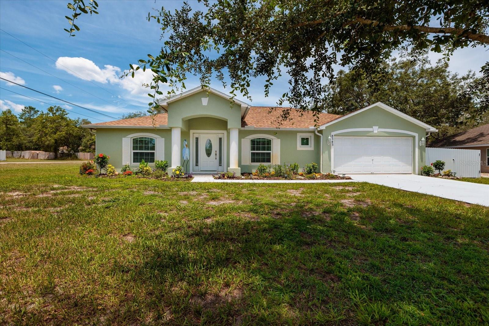 Welcome to this updated 3-bedroom, 2-bath residence set on a 0.46-acre lot, thoughtfully improved from top to bottom. New tile flooring carries through the main living areas and extends seamlessly onto both the front and back porches for a unified, finished look. The kitchen has been refreshed with a new tile backsplash, added cabinetry for increased storage, butcher-block countertops, a new refrigerator and microwave, and stone-veneer detailing on the island and cabinet sides. Both bathrooms have been fully updated with new cabinets, sinks, toilets, plumbing fixtures, quartz countertops, and beautifully tiled showers, creating a consistent modern aesthetic throughout the home. Additional improvements include new interior and exterior paint, generator hookup, updated sprinkler system, new septic lift pump, and new front landscaping. The property is fully fenced with new 6-ft galvanized fencing. A mini-split A/C, insulated ceiling, and LED lighting enhance the detached garage, while the workshop also features updated electrical and LED lighting—ideal for storage, hobbies, or workspace needs. This location places you minutes from some of Hernando County’s most iconic attractions, including Weeki Wachee Springs, Buccaneer_Bay, the crystal-clear Weeki Wachee River for kayaking and paddleboarding, and the coastal restaurants and marinas of Hernando_Beach. The Gulf of Mexico is just a short drive away, offering fishing, boating, and sunset views. A move-in-ready property with extensive upgrades in a highly desirable outdoor-lifestyle corridor—schedule your showing today.