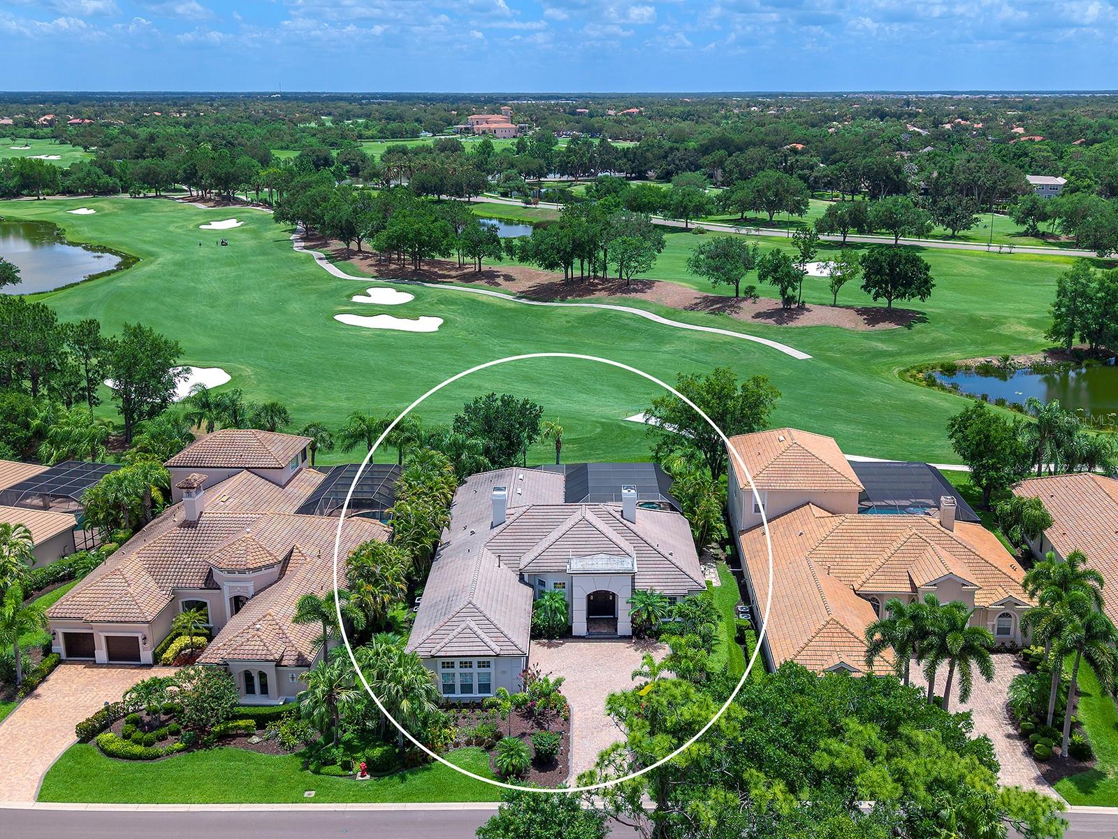 Located in the renowned Greystone enclave of Lakewood Ranch Country Club, this immaculately home has gorgeous upgrades that rival the beautiful golf course views over the second hole of the Kings Dune golf course.  This gorgeously renovated home was completely remodeled and updated in 2021-2022 for modern, upscale living and has been meticulously maintained and upgraded ever since.  Evoking a sense of elegance and effortless entertaining, the timeless updates throughout the residence include a cool color palette that matches every design style, luxury oak vinyl flooring, designer light fixtures, plantation shutters and black out shades, LED lighting throughout, and elegant one-of-a-kind design features through. Enter through a solid door surrounded by lush, blooming, recently upgraded landscaping into an elegant foyer with expansive golf course views.  The formal living room showcases a gas fireplace for cozy gatherings, and a stunning wine showcase cellar with lighting and polished porcelain tile to display your collection.  Entertaining is a delight in the formal dining room with bay style window, designer chandelier, and custom butler’s bar with wine refrigerator that leads into the kitchen for effortless entertaining.   Adorned with designer finishes, the chef’s kitchen features a central prep island and outer island with bar seating, refinished wood cabinetry with pull-out drawers and hidden outlets, brushed gold hardware, Calcutta Laza quartz counters and full-height backsplash, and Culligan water filter.  Cooking is a delight on the stainless-steel appliance suite featuring KitchenAid range with dual fuel, built-in wall oven,  built-in microwave, dishwasher, refrigerator with glass door, and even an new ice maker.  The heart of the home is the family room that shines with an Italian porcelain tile feature wall and accent puck lighting.  An adjacent dinette with large aquarium window is perfect for casual meals.  Entertaining spills out onto the lanai with panoramic views of the golf course and adjacent lakes through 2025 panoramic screen enclosure, travertine covered entertaining areas, and refinished pool and raised spa.  Enjoy meals alfresco from the new 2026 outdoor kitchen by Synergy with stainless steel grill, bar refrigerator, and ice maker.  Inside the primary suite is a study in relaxation with ultra-plush carpeting, large windows highlighting the views, and dual walk-in closets.  The magazine-worthy primary bathroom will spark envy with its expansive vanity, freestanding tub, frameless glass walk-in shower, accent tile, and luxe details. Three guest suites offer your guests privacy and comfort, along with two full guest bathrooms. The rear guest bedroom can also be used as a study, bonus room, or media room resulting in a truly flexible floor plan that works for your life.  Completing this opulent home is a renovated laundry, smart mudroom with an enormous amount of storage you won’t find in any other home, 3-car oversized side-loading garage with space for a golf cart plus 3 cars, and grounds maintenance and cable included in your HOA dues.  Recent upgrades include a freshly painted exterior, additional garage LED lighting, 2025 EcoShield insulation, 2026 electric service boxes, 2026 sewer clean out, and more.  Appreciate a state-of-the-art fitness center, clubhouses, junior Olympic-sized pool, four 18-hole championship golf courses, tennis and pickleball and more by becoming a member of the Lakewood Ranch Country Club.