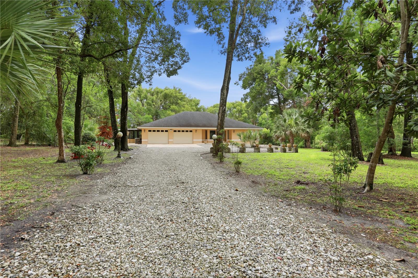 TUCKED AWAY ON Strathacona Avenue in a quiet semi-rural setting, this one-of-a-kind property offers the perfect blend of privacy and convenience - just minutes from Historic Downtown DeLand and Stetson University.  Built with quality and longevity in mind, this custom-designed home features solid poured-concrete construction, thoughtful craftsmanship, and unique architectural details throughout.  Filled with years of cherished memories, it now presents an incredible opportunity for its next owner to create something truly special.  Step inside through the expansive foyer and into the impressive 42" x 15" great room and dining area, an ideal space for entertaining family and friends. The spacious kitchen boasts 42 inch cabinetry, elegant glass-front display cabinets, room for a double refrigerator, and ample space to add a large kitchen center island.  The oversized primary suite measures an impressive 29' x 13' and offers flexibility for future expansion, including the potential to create a third bedroom.  The suite also includes a large garden bath and walk-in closet.  The second bedroom enjoys access to the second bathroom, making it perfect for guests, extended family, or returning college students.  As an added bonus, the large walk-in closet doubles as a reinforced safe room, providing peace of mind during storm season.  Step outside onto the rear deck and enjoy your morning coffee while taking in the natural beauty of the surrounding acres.  Additional features include a whole-house generator, a sidewalk that wraps around the entire home, and a 20' x 12' powered workshop for hobbies, projects or extra storage.  The property also includes a separate half-acre parcel located off S Woodward Avenue, adding easement rights and your own private road access to the subdivision, and income possibilities.  No HOA to deal with - store your RV or boat with no problem.  Oversized garage with second workshop inside.  If you have been searching for a private country retreat with endless potential, yet close to the heart of DeLand, this exceptional property is ready to welcome its next chapter and a lifetime of new memories.