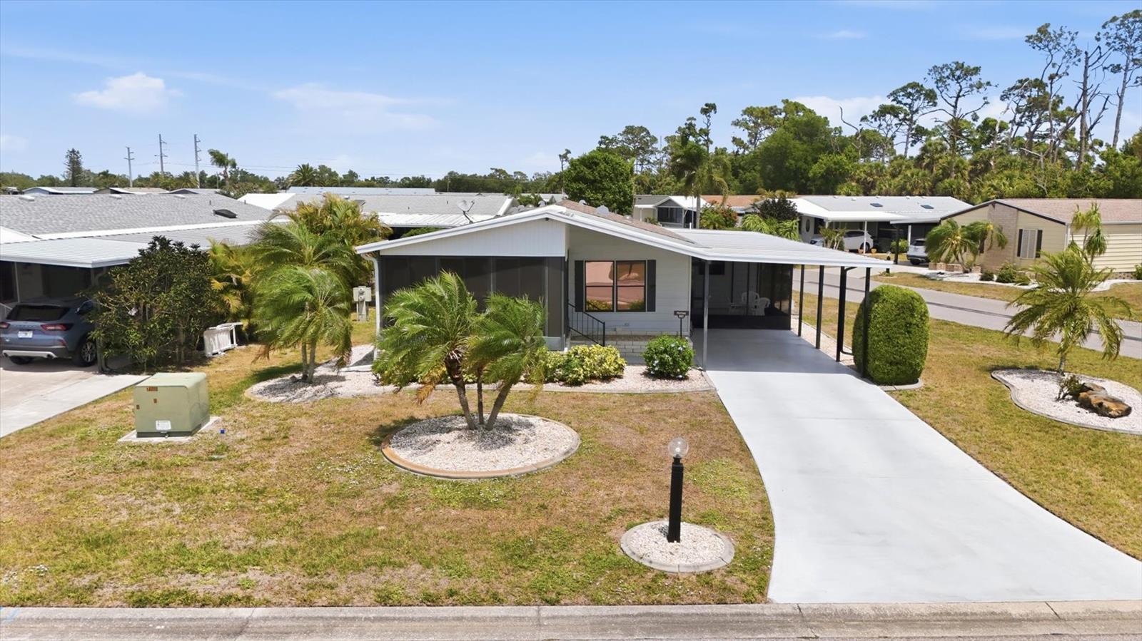 WOW...$13,000 PRICE IMPROVEMENT..MOTIVATED SELLER! An easily accessible corner lot enhances this nicely maintained, 2-bedroom, 2-bathroom home in Tangerine Woods. This highly sought after, over 55, gated community, is an active and friendly place to live! For your leisurely pleasure, this community provides you with a large, heated pool and clubhouse, an exercise room and library, tennis, and pickleball courts, walking trails, shuffleboard and so much more! This perfectly priced, turn-key furnished home, boasts a new front lanai, renovated carport, newer skylights, 2-year-old washing machine, and a 4-year-old roof. The kitchen has just the right amount of counter space and cupboards, a breakfast bar, skylight, and large pantry. The large furnished master bedroom is enhanced with its ensuite bathroom, a skylight, and 2 large walk-in closets. The guest bedroom includes a large built-in closet. The screen enclosed lanai just off the family room, offers you a comfortable second space for outdoor enjoyment and a place to unwind and relax and even includes a mini fridge. For peace of mind, this home had a new roof in 2022 and is in an X Flood Zone. This move-in ready home can serve as your permanent residence or seasonal home-away-from-home! Tangerine Woods is located just minutes from the quaint locally owned shops & restaurants off historic Dearborn Street, both Englewood and Manasota Key beaches, casual dining and outdoor entertainment, world class fishing, and many challenging golf courses to choose from. Tangerine Woods and this home offer you a piece of our Paradise in Englewood, Florida! Schedule your showing today!