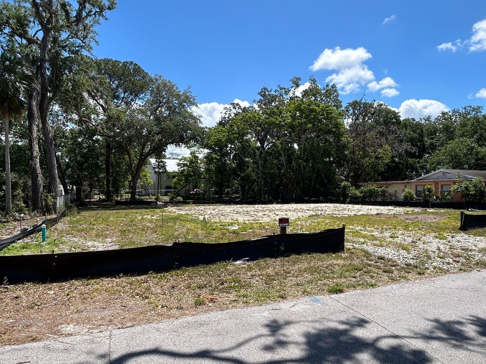 Perfect place for your new home or investment property on this generous lot, measuring almost a half acre (110 x 184, .46 acre). Approved for either a single-family dwelling, modular, or a duplex, this property offers flexibility for your plans. The land is cleared and ready to build.  Also has a temporary power pole for when you go to build.  The lot is partially fenced along the back with a 6 ft chain link fence and the sides with a 5 ft fence . Enjoy the convenience of being just a short distance from shopping, beaches, and public transit and to downtown New Port Richey. Have peace of mind that this property did not take on any water from any hurricane Don't miss out on this exceptional opportunity!