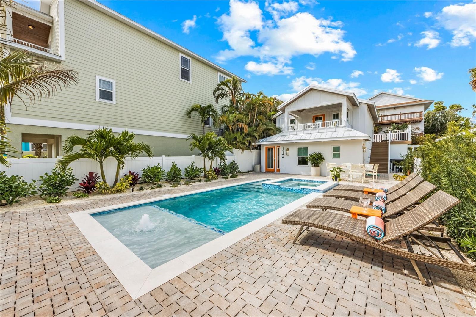 Completely remodeled 4-bedroom, 4-bathroom coastal retreat blending the charm of an original beach home with modern luxury. The upstairs features two spacious king-sized suites, each with beautifully appointed en-suite bathrooms. The rear primary suite opens to an expansive private deck with a comfortable seating area, while the front suite offers its own deck—perfect for morning coffee or relaxing evening cocktails.
On the ground floor, a king bedroom shares a double-vanity Jack-and-Jill bathroom with the bunk room, providing ideal accommodations for guests and family. A convenient full bath with tub, located just off the living area, also serves as a pool bath with direct exterior access.
The spacious open floor plan seamlessly connects the living and dining areas, creating an inviting space for entertaining and everyday living. The fully updated kitchen features all-new stainless steel, state-of-the-art appliances and modern finishes.
Step outside to your private oasis featuring a stunning custom heated pool with spa and swim ledge, perfect for relaxing after a day at the beach. Ideally located within walking distance to Anna Maria’s renowned white sand beaches, charming shops, and popular restaurants, this home offers the perfect blend of coastal living, modern comfort, and island convenience.