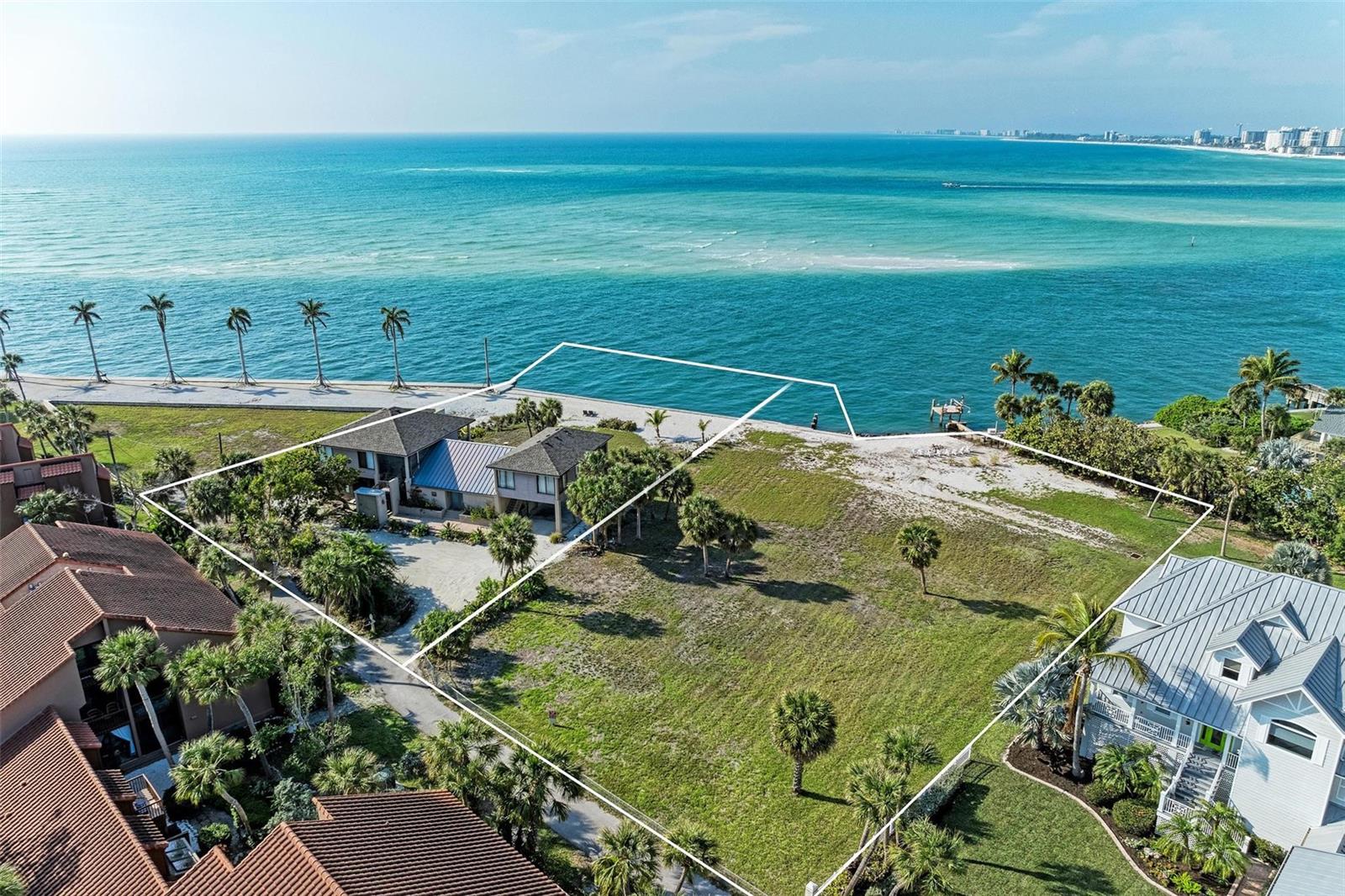 A RARE OFFERING to purchase two Gulf Front building lots side by side (Parcel ID Numbers-0080010021 & 0080010023) where Sarasota’s Big Pass meets the Gulf of Mexico providing one of the best panoramic views in the area, located on a private gated lane.  Combine both lots for a total of close to 1.4 acres with approximately 215 feet of seawall and design a world class estate that has one of the best waterfront views in Sarasota County or create two separate grand estates as this listing provides a rare canvas for architectural creativity.  This listing includes a home with 4 separate living units with their own entrances.  A short walk takes you to the heart of Siesta Key Village, a bustling hub of shopping, dining, and entertainment.  Indulge in the splendor of Siesta Key Beach (voted #1 beach), famed for its crystal-clear waters and powder-fine sands, just a stone's throw away. A quick drive over the North Bridge connects you to downtown Sarasota, Sarasota Airport, and a myriad of shopping, dining, and cultural options, ensuring convenience without compromising tranquility.