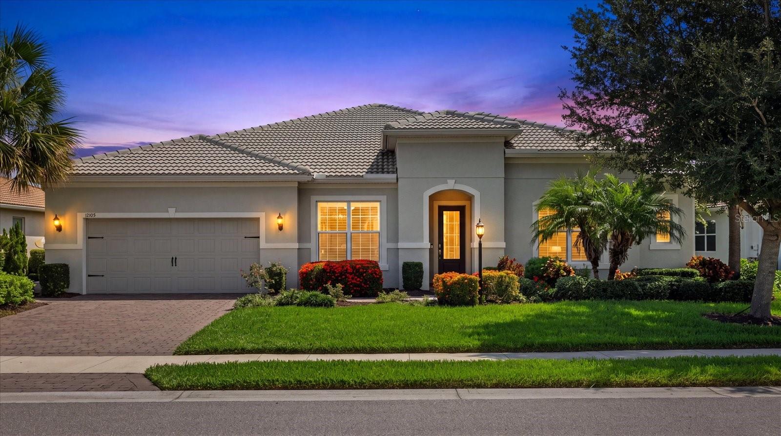 Virtually Staged. THE PREMIER NOBILITY MODEL IN MALLORY PARK. Positioned on the community's most desirable lakefront homesite, this residence showcases breathtaking water and preserve views, the highest upgrade package offered for both structural and interior selections, Level 6 wide-plank tile flooring, soaring 12-foot ceilings with 8-foot doors, a custom coastal media wall with electric fireplace, a panoramic screened lanai with a fully custom saltwater pool and spa, an oversized backyard with room for a dog run or additional outdoor living, and an upgraded side walkway providing convenient access to the garage. This is a rare opportunity to own one of the most extensively upgraded and aggressively priced homes in all of Mallory Park.

Experience the best of Florida living in this stunning coastal-inspired home designed for everyday living and entertaining. The open-concept floor plan is highlighted by soaring ceilings, plantation shutters throughout, and an expansive great room featuring a custom built-in entertainment wall with an electric fireplace. At the heart of the home, the gourmet kitchen boasts an oversized island, abundant cabinetry, a spacious walk-in pantry with custom shelving, and an adjoining dining area perfect for gatherings.

The private owner's retreat is a true sanctuary, offering peaceful pond views, its own secluded den, a spa-inspired bath, and an oversized custom walk-in closet with built-ins. Two secondary bedrooms are connected by a thoughtfully designed Jack-and-Jill bath, each featuring its own vanity, walk-in closet, and shared shower. A fourth bedroom is ideal as a guest room, home office, fitness room, game room or flex space. Additional highlights include a dedicated planning center ideal for homework or a home office, a spacious laundry room with built-in cabinetry, sink, and additional refrigerator, a convenient drop zone, Halo whole-home water filtration system, and an oversized three-car tandem garage.

Open the dramatic zero-corner sliding glass doors and step into your private outdoor oasis, where a custom saltwater pool and spa await. The panoramic screen enclosure captures the stunning lake and preserve views, creating the perfect setting to relax and entertain year-round.

Life in Mallory Park is about so much more than the home, it's about the lifestyle. This maintenance-free community offers exceptional amenities including a clubhouse with a fitness center and gathering room, resort-style pool and spa, pickleball and basketball courts, playground, scenic walking trails, and more. Adjacent Bob Gardner Park offers walking and biking trails, dog park, sports fields, and playgrounds.

Ideally located in the heart of Lakewood Ranch, Mallory Park places you just minutes from Lakewood Ranch Main Street, Waterside Place, University Town Center, and Downtown Sarasota, with world-renowned Gulf Coast beaches including Siesta Key, Lido Key, and Anna Maria Island just a short drive away. Families will also appreciate the community's direct walking path to Gullett Elementary and Mona Jain Middle School, while Lakewood Ranch High School is less than five minutes away.

This is more than just a home, it's an opportunity to embrace the luxury, convenience, and vibrant Florida lifestyle that makes Lakewood Ranch one of the nation's most desirable places to live.