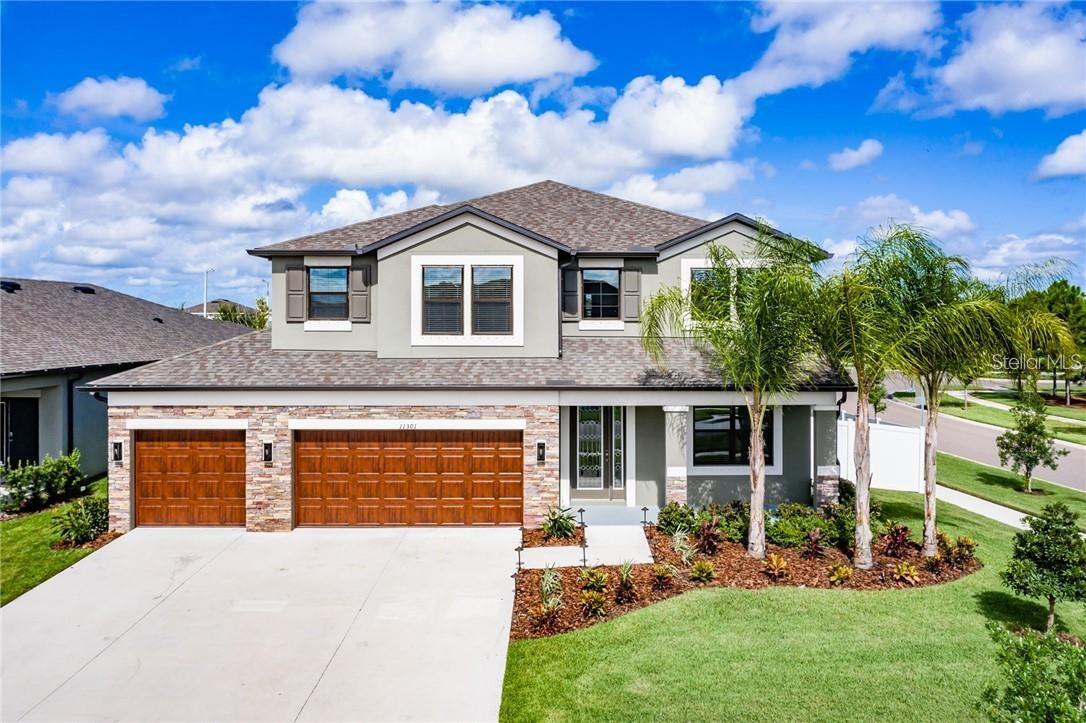 Qualified buyers can take advantage of a rare 2.75 VA assumable interest rate. Uncompromising scale, luxury details, and prime placement meet at 11301 Alachua Creek Lane. Boasting 3,600 square feet of meticulously designed living space, this 5-bedroom, 3-bathroom residence commands a prominent corner lot with a rare feature such as a 4-car garage for all your mechanical toys. The oversized diveway is spacious enough to fit 6 vehicles. Kitchen is a Chefs dream with huge kitchen island, extended counter-tops with butler's pantry. Laundry room has ample space with a utility sink, upgraded washer and dryer with aesthic cabinets for storage. Designed with entertaining in mind, the home comes fully pre-wired for immersive whole-house surround sound. Everyday peace of mind is built right in thanks to a hard-wired security camera system which is included, while seasonal decorating is made effortless with pre-wired roofline holiday lighting controls. Upstairs, a sweeping huge loft anchors the floorplan, offering versatile space for a home theater, play area, or lounge. The owner's suite feels like a private resort, highlighted by a majestic tray ceiling and a spa-inspired bath featuring a deep garden soaking tub, separate shower and dual vanities with granite counter-tops. Enjoy the energy efficency with Solar Panels that will keep your eletric bills low. Best of all, enjoy unmatched convenience: step out your front door and walk right across the street to the resort-style community pool and clubhouse facilities. Exceptional square footage, rare garage capacity, and smart upgrades make this property a rare find in today's market!