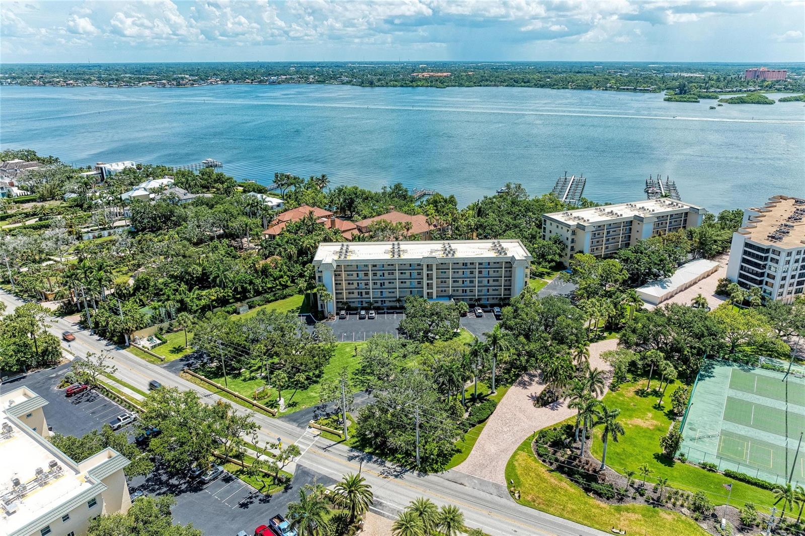 Welcome to the beautifully maintained and highly sought-after Gulf to Bay community on Siesta Key—Bay Tree Club. This charming 2-bedroom, 2-bath end unit is situated on the second floor, offering an abundance of natural light through its four side windows. Enjoy open views of the swimming pool and a picturesque glimpse of Little Sarasota Bay in the distance. Bay Tree Club boasts private deeded beach access, a bayside swimming pool with a picnic and grill area, and a gulf-side swimming pool equipped with additional grills and picnic spaces. The community also features beautifully maintained boat docks for your convenience, along with kayak and canoe storage onsite. Each unit includes a private gulf-side cabana for storing beach chairs and toys. The grounds are impeccably kept, and the community welcomes two pets, each weighing no more than 35 pounds. There is flexible rental availability, with a one-month minimum during peak season and a two-week minimum in the offseason. This Furnished unit is ready for its new owner!