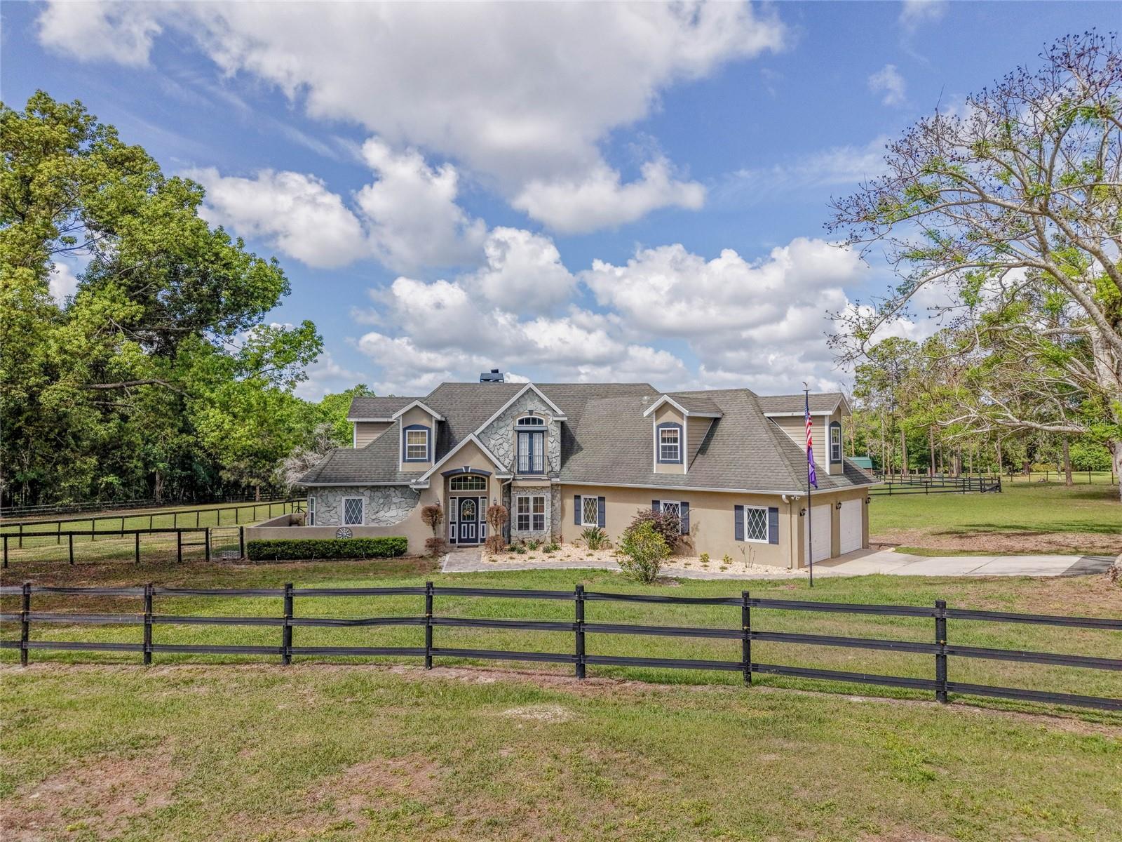 A true HIDDEN GEM, FRENCH FARMHOUSE STYLE offering unparalleled serenity and luxury. Offered for the first time by its original owners, this custom-built estate sits on 11 MOL private acres and boasts breathtaking views of the rolling hills stretching from Dade City toward Orlando.
This 2007-built home was designed for ultimate privacy, featuring no rear neighbors and only one neighbor to the side. 

The interior offers a thoughtful layout including: - 4 spacious bedrooms and 2.5 bathrooms - A dedicated home office - An expansive bonus room (easily convertible to a 4th bedroom) - Exquisite craftsmanship and two cozy wood-burning fireplaces, including one in the primary suite, abundance of storage opportunity and closets - An open floor plan with a kitchen, dining, and living room combo.

The CHEF's KITCHEN features beautiful custom designed PINE cabinets, granite countertops, gas range, and plenty of storage in your large pantry!!

The outdoor oasis features a screened-in pool overlooking picturesque pastures and wooded vistas. Pebble Tec pool surface with a LIFETIME guarantee. OUTDOOR lover's dream with daily turkey and deer sightings. For equestrian enthusiasts, this fully fenced estate is equestrian-ready, featuring 5 horse stalls, a tack room, and a boarding shed—offering a unique opportunity to step into an established boarding operation.

Additional premium features include: -Icynene Insulation throughout for reduced energy consumption -DOUBLE INSULATED WINDOWS -A 500-gallon propane tank - A dedicated RV pad and a 20x20 storage shed. This exceptional property offers a rare combination of luxury, privacy, and versatility. It is ideal for RV owners, hobbyists, gardening or those seeking a private family compound. 
Please let me know if you would like to schedule a private tour or if you have any questions regarding this unique opportunity.