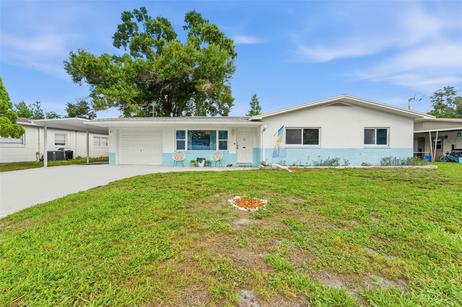 Just a 5-minute drive to all the restaurants, bars, and shops that make Seminole Heights so beloved, this peaceful retreat lets you have it all! Set on a relaxing, spring-fed lake perfect for launching your kayak or paddle board, this well-maintained concrete block home offers 3 bedrooms, 2 baths, a 1-car garage, PLUS a shed with electricity for extra storage and projects. Tucked away on a quiet dead-end street! Inside, the open-concept kitchen with granite countertops and stainless steel appliances is made for cooking and entertaining. A sunroom/Florida room with extra-large windows overlooks the backyard and serene lake — the perfect spot for morning coffee. Step outside and you'll find a fire pit ready for cool evenings, towering Cypress trees, and gorgeous water views. This home has been lovingly cared for with major updates throughout: roof (2020), water heater (2020), washer (2023), and new garbage disposal. Fresh touches include new lighting in the kitchen, dining area, living room, and guest room; a newly painted hallway bathroom (walls and ceiling); painted guest room and trim; and a refreshed primary bathroom with trim painted throughout the primary bedroom. The hallway bathroom also features a new countertop and sink, and both toilets have been replaced. Strong block construction, tons of storage, and a location that puts you minutes from Aldi and everything Seminole Heights has to offer, this one checks every box. (HVAC 2018)