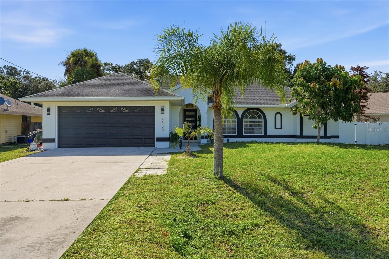 Welcome to this beautifully remodeled 3-bedroom, 2-bathroom concrete block home, where thoughtful updates, stylish finishes, and a functional layout create a truly move-in-ready property. Built in 1995 and located in Flood Zone X, the home offers the added benefit of flood insurance generally not being required by lenders. From the moment you arrive, you’ll appreciate the inviting curb appeal, highlighted by a covered front porch, elegant arched windows, brand-new gutters, and a spacious 2-car garage. The fully fenced backyard offers privacy and plenty of room for outdoor dining, entertaining, pets, gardening, or simply enjoying the Florida sunshine. Step inside to a bright, beautifully updated interior featuring luxury vinyl plank flooring, vaulted and tall ceilings, and a comfortable open layout filled with natural light. The cohesive finishes give the home a fresh, modern feel, while the split-bedroom floor plan provides separation between the primary suite and the two additional bedrooms. At the heart of the home, the redesigned kitchen features quartz countertops, abundant cabinetry, generous workspace, and a clean, modern aesthetic that flows seamlessly into the main living and dining areas. Just beyond, the expansive Florida room adds valuable flexibility and can serve as a second living area, game room, home office, fitness space, playroom, or a combination of uses. An interior laundry room with a utility sink adds even more everyday convenience. The spacious primary suite includes two walk-in closets and a beautifully remodeled en-suite bathroom with a dual-sink vanity. The additional bedrooms and second full bathroom are located on the opposite side of the home, offering comfort and privacy for occupants or guests. Both bathrooms have been tastefully updated with stylish finishes, including distinctive green designer tile that adds character while complementing the home’s timeless, modern design. Conveniently located in the heart of North Port, this home provides easy access to shopping, dining, parks, golf courses, and everyday conveniences, with I-75 just minutes away. Spend your weekends visiting Warm Mineral Springs, attending Atlanta Braves Spring Training at CoolToday Park, or enjoying the beautiful Gulf Coast beaches. With its concrete block construction, extensive renovations, flexible living space, fenced backyard, and convenient location, this North Port home is ready to welcome its next owner. Schedule your private showing today.
