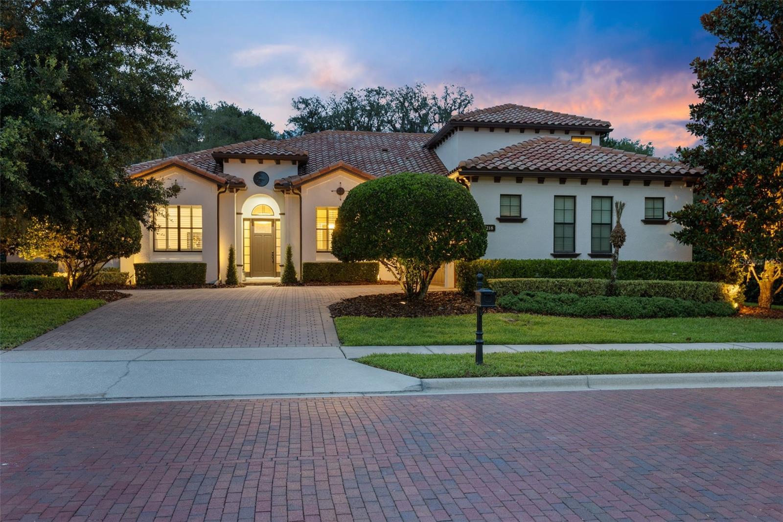 Welcome to a luxury residence where executive living meets active family life. Nestled within the exclusive gated enclave of Acuera, a boutique community of only 38 estate homes, 2218 Soaring Eagle Place has been thoughtfully reimagined for today's modern household—where sophisticated design, effortless entertaining, and an active lifestyle come together in perfect harmony.

Set on a premium homesite backing to tranquil conservation, this exceptional property offers nearly 5,000 square feet of refined living space with five bedrooms, a private office, a dedicated wellness studio, a media room, and beautifully connected gathering spaces designed for both grand entertaining and everyday family moments.

At the heart of the home is a spectacular designer kitchen, meticulously renovated with custom cabinetry, an oversized center island, premium appliances, gas cooking, and a dual Sub-Zero wine refrigerator—creating a stunning centerpiece for celebrations, holidays, and weeknight dinners alike. The open-concept design flows seamlessly into the family room and casual dining area, where walls of glass invite natural light and showcase the resort-style outdoor living beyond.

Designed with today's busy family in mind, the home embraces the rhythm of modern life. A private pickleball sports court creates an incredible space for friendly competition and year-round recreation, while the custom-built mudroom with wood lockers provides an organized landing zone for backpacks, sports equipment, uniforms, and cleats after a long day of activities. The oversized three-car garage is also EV-ready, reflecting the forward-thinking conveniences expected in a home of this caliber.

The first-floor primary suite offers a peaceful retreat with direct access to the lanai, generous proportions, a spa-inspired bath, and oversized walk-in closets. Upstairs, additional bedrooms are complemented by a dedicated wellness studio that provides the ideal environment for strength training, Peloton rides, yoga, recovery, or personal coaching, while remaining flexible enough to become a media room, teen retreat, golf simulator, creative studio, or additional living space as your family's needs evolve. A separate media room and full bath complete this exceptionally versatile upper level.

Step outside and experience your own private resort. The expansive screened lanai features a summer kitchen, inviting gathering areas, and a sparkling saltwater pool with infinity spa, all surrounded by lush landscaping and serene conservation views that create an extraordinary sense of privacy.

Additional highlights include structured audio, tankless hot water, abundant storage throughout, public utilities, and exclusive community access to the Wekiva River. Located along the prestigious Markham Woods corridor, residents enjoy convenient access to premier golf, boutique shopping, dining, top-rated schools, major highways, and Orlando's business and entertainment hubs.

More than a luxury home, 2218 Soaring Eagle Place is designed for families who want to thrive—where championship dreams begin on the private court, wellness becomes part of the daily routine, unforgettable celebrations gather around the kitchen island, and every detail supports a life well lived.
