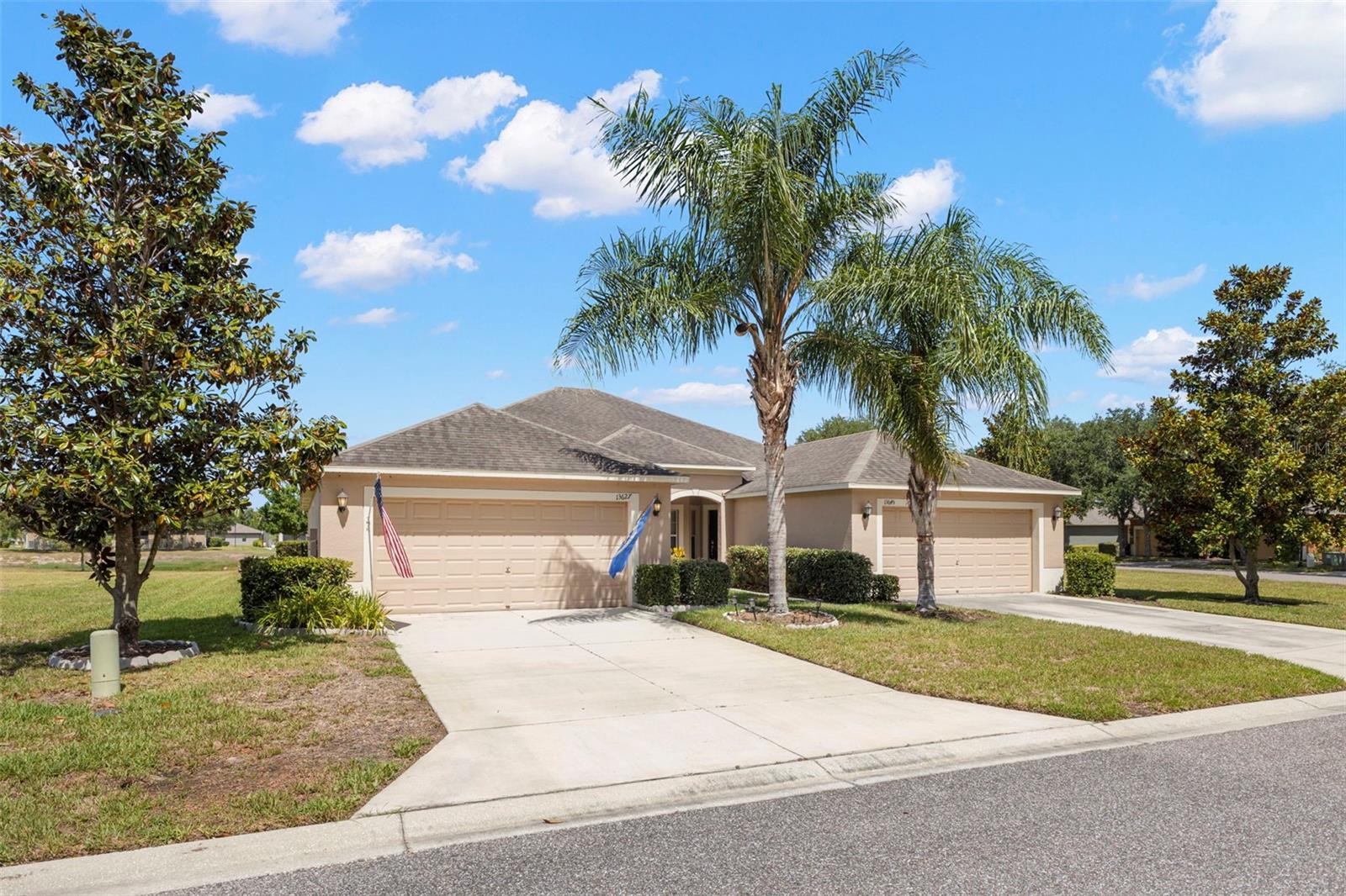 Welcome home to this light-filled and beautifully maintained 3-bedroom, 2-bath villa offering spacious living and serene pond views. Step through the front entry and to your left you'll find a convenient laundry room with extra cabinetry for storage, a bonus refrigerator and freezer, and direct access to the attached 2-car garage. The open-concept floor plan features soaring volume ceilings and abundant natural light throughout. The kitchen is designed for both everyday living and entertaining, complete with stainless steel appliances, a breakfast nook, breakfast bar seating, and seamless flow into the dining and living areas. The secondary bedrooms offer ample closet space and easy access to a full guest bath with a tub/shower combination. Privately situated off the living room, the spacious primary suite features a large walk-in closet and an en-suite bath with dual vanities and an oversized walk-in shower. Relax and unwind in the screened lanai overlooking a peaceful pond, creating the perfect backdrop for morning coffee or evening sunsets. Additional highlights include laminate wood flooring in all bedrooms and tile flooring throughout the main living areas. The low-maintenance lifestyle is enhanced by an HOA that includes lawn care, trash service, roof maintenance, and exterior painting, allowing you to enjoy carefree Florida living at its best. Enjoy the community amenities that include a clubhouse with fitness center, playground, basketball and tennis courts and pool! Come and see this terrific home today!