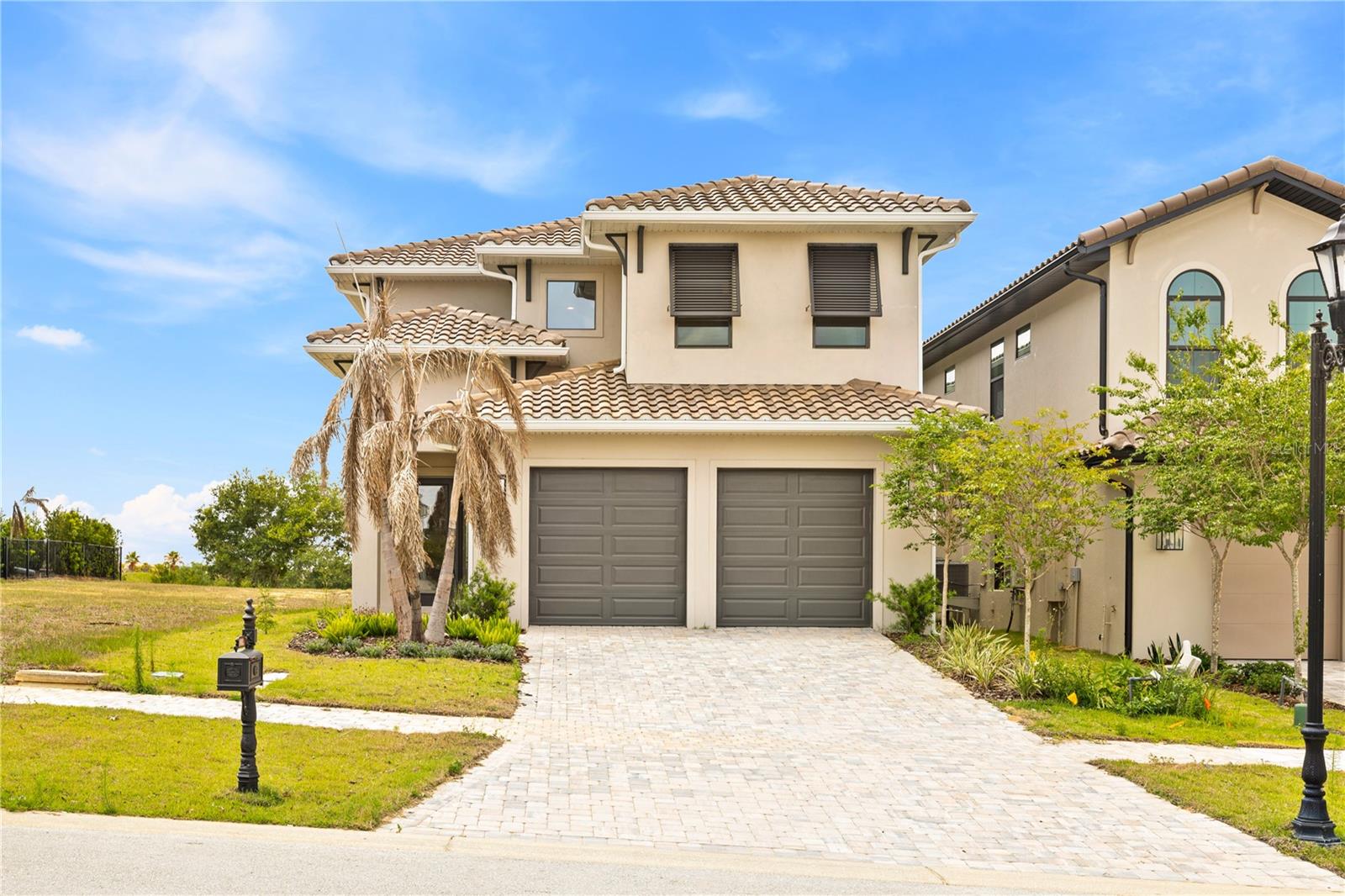 Luxury living in the highly sought-after gated community of Bella Collina, offering breathtaking views of the rolling hills. BRAND NEW HOME + EXCLUSIVE RATES WITH SELLER'S PREFERRED LENDER + $20,000 TOWARD CLOSING COSTS.

This stunning two-story residence showcases soaring ceilings, an open-concept floor plan, and elegant finishes throughout. The spacious living area features an electric fireplace and oversized sliding glass doors that seamlessly connect the indoor and outdoor spaces.

Step outside to your private outdoor oasis featuring a summer kitchen, an expansive covered lanai, and a resort-style private pool with spa—perfect for entertaining or relaxing while enjoying the beautiful views.

The main floor is highlighted by porcelain tile flooring throughout, combining durability with modern elegance. The gourmet kitchen is a chef’s dream, featuring sleek modern wood cabinetry, a large island, spacious countertops, and top-of-the-line appliances.

A private guest suite with its own bathroom and walk-in closet is conveniently located on the first floor, providing comfort and privacy for visitors.

Upstairs, luxury vinyl flooring leads to the impressive primary suite, a true retreat featuring a spa-inspired bathroom with dual vanities, a soaking tub, and a spacious walk-in closet. Step onto the private balcony and enjoy the spectacular panoramic views.

A spacious mezzanine provides the perfect flex space for a second living area, media room, or home office. The upper level also features a fully equipped laundry room for added convenience.

Residents of Bella Collina enjoy world-class amenities, including a championship golf course, clubhouse, resort-style pool, fitness center, full-service spa, tennis courts, pickleball courts, multiple dining venues, and scenic walking trails.

Ideally located just minutes from downtown Winter Garden, the Clermont Chain of Lakes, the Florida Turnpike, and approximately 30 minutes from Walt Disney World Resort, this home offers both luxury and convenience.

Don’t miss this rare opportunity to own a spectacular home in one of Central Florida’s most exclusive communities.
