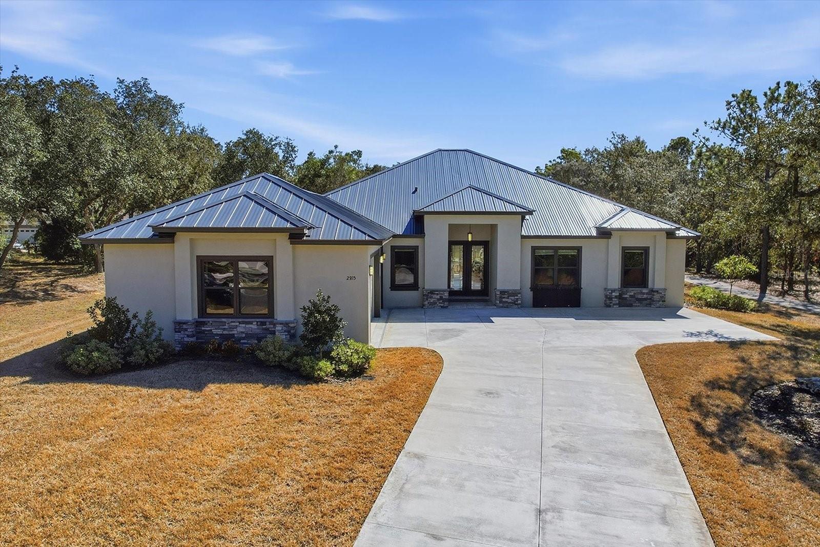 Offering Free temporary buydown, lowering the buyer interest rate for the first year with Preferred Lender. Also Offering sellers Concessions. Check out this 3 Bedroom 3 Bathroom 3 Car Garage Dream Golf Course Home at Citrus County's world-renowned Black Diamond Ranch. Like-new 2024-built residence offers a stunning view above street level from the 60 ft wide lanai in back on the Ranch Course Tee Box of the 17th Hole. No expense was spared to create this one-of-a-kind home boasting daily sun and moonrises and a view down the 17th fairway shared from almost every room! Premium standing seam metal roof – offering exceptional durability, energy efficiency, and timeless architectural appeal. Gourmet kitchen equipped with premium appliances, abundant cabinetry, and a large center island – perfect for casual dining or grand entertaining. Spacious primary suite boasting a luxurious bathroom with free-standing soaking tub, crown molding, and generous walk-in closets. Also features crown molding, tray ceiling and its own stunning view out the sliding glass doors leading to the covered lanai. With the walk-in shower built for two or the free-standing soaking tub enojy the comforts of a large primary bath. Backlit mirrors against vertical black tiles add ambiance and functionality while the hanging chandelier and recess lights provide beauty and illumination. With built-in closet organizers in each closet and throughout the house including the kitchen pantry this home provides ample amount of storage and space. Your guests will enjoy their own privacy in the ensuite bedroom with walk-in closet and the back bedroom offers sliding glass doors to the lanai. (Recent LIV Golf Promotion Event January 8–11, 2026) The developers of Black Diamond Ranch just invested millions in improvements to the Ranch course and homeowners will reap the benefits for years to come. Ask about membership opportunities as golf membership is not a requirement of living in this 24-hr guard gated community and access to the clubhouse with private dining, sports facilities and pool are very reasonable for such amenities. Call Today!!