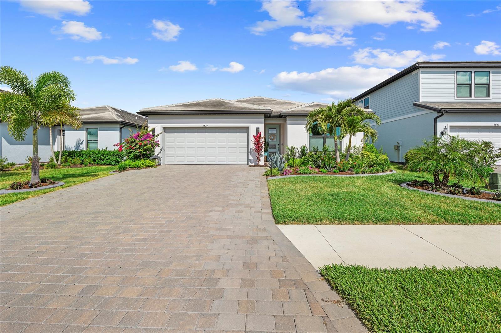 Welcome to this STUNNING, DESIGNER-INSPIRED coastal residence, built in 2023 and ideally situated in the highly sought-after gated community of SAPPHIRE POINT at Lakewood Ranch. Showcasing elevated COASTAL COOL interiors and thoughtfully curated upgrades throughout! This exceptional 3 BEDROOM, 2 BATH POOL home offers 1,650 SQ FT under air and 2,431 TOTAL SQ FT designed for effortless luxury living. Surrounded by lush tropical landscaping with additional added SEVEN PALM TREES, custom arbors, concrete landscape edging, and a beautifully designed FENCED YARD for your furry friends. The exterior creates a private resort-style setting with exceptional curb appeal complete with IMPACT GLASS THROUGHOUT. Permanent Designer Outdoor POOL AND HOME lighting by "JELLYFISH-STYLE LIGHTING" welcomes you to an OMBIENCE YOU WILL LOVE, PLUS illuminated walkways, and outdoor spotlights create a warm, ambiance day and night. Designed for seamless indoor-outdoor living, the expansive covered and screened lanai features a CUSTOM HEATED SALTWATER POOL with WATERFALL FEATURE, panoramic SCREEN ENCLOSURE, hurricane screens (to protect lanai furniture while away), and tranquil preserve views—creating the ultimate year-round entertaining retreat. Inside, every detail has been thoughtfully elevated finishes and modern coastal elegance. Experience the timeless beauty of hardwood with unmatched durability with NEW Mohawk RevWood Premier Laminate flooring in Sailor's Rope Oak design! With superior scratch and water resistance, and unbeatable fade protection for your peace of mind throughout the ENTIRE home. Features include CUSTOM shades and curtains, upgraded DESIGNER lighting, ceiling FANS, and CUSTOM CABINETRY! The chef-inspired kitchen is a true showpiece featuring HIGH LEVEL QUARTZ COUNTERTOPS, an INDUCTION STOVE, FARMHOUSE SINK, ELEVATED AQUA TILE BACKSPLASH, under-cabinet lighting, upgraded BRASS and silver hardware, PREMIUM BESPOKE SAMSUNG APPLIANCE SUITE, and custom CLOSET BY DESIGN pantry shelving AND CLOSET DESIGNS. HIGH END WALL PAPER AND DESIGN THROUGHOUT, while the luxurious primary suite offers a serene retreat complete with Ensuite Bath with Dual Vanities and Custom Closet Organization System! Additional premium upgrades include WHOLE HOME WATER FILTRATION, WATER SOFTENER SYSTEM, insulated garage door, ceiling, & epoxy garage floor, widened driveway, front walkway lighting, upgraded laundry room storage, and newer front-load washer and dryer on pedestals. Furnishings are negotiable outside of the sale price excluding the wall art and lanai furniture, offering the opportunity for a beautifully curated move-in-ready experience. Residents of Sapphire Point enjoy RESORT-STYLE AMENITIES including a COMMUNITY POOL, clubhouse, fitness center, dog park, basketball court, playground, and maintenance-free living within one of Lakewood Ranch’s most desirable gated communities. Ideally located approximately 18 miles to the world-renowned Gulf beaches, under 10 miles to University Town Center shopping and dining, and conveniently zoned for the NEW LAKE MANATEE K-8 SCHOOL opening for the 2026–2027 school year, this exceptional residence offers the perfect blend of luxury, lifestyle, and location. MAKE YOUR SHOWING APPOINTMENT TODAY!!