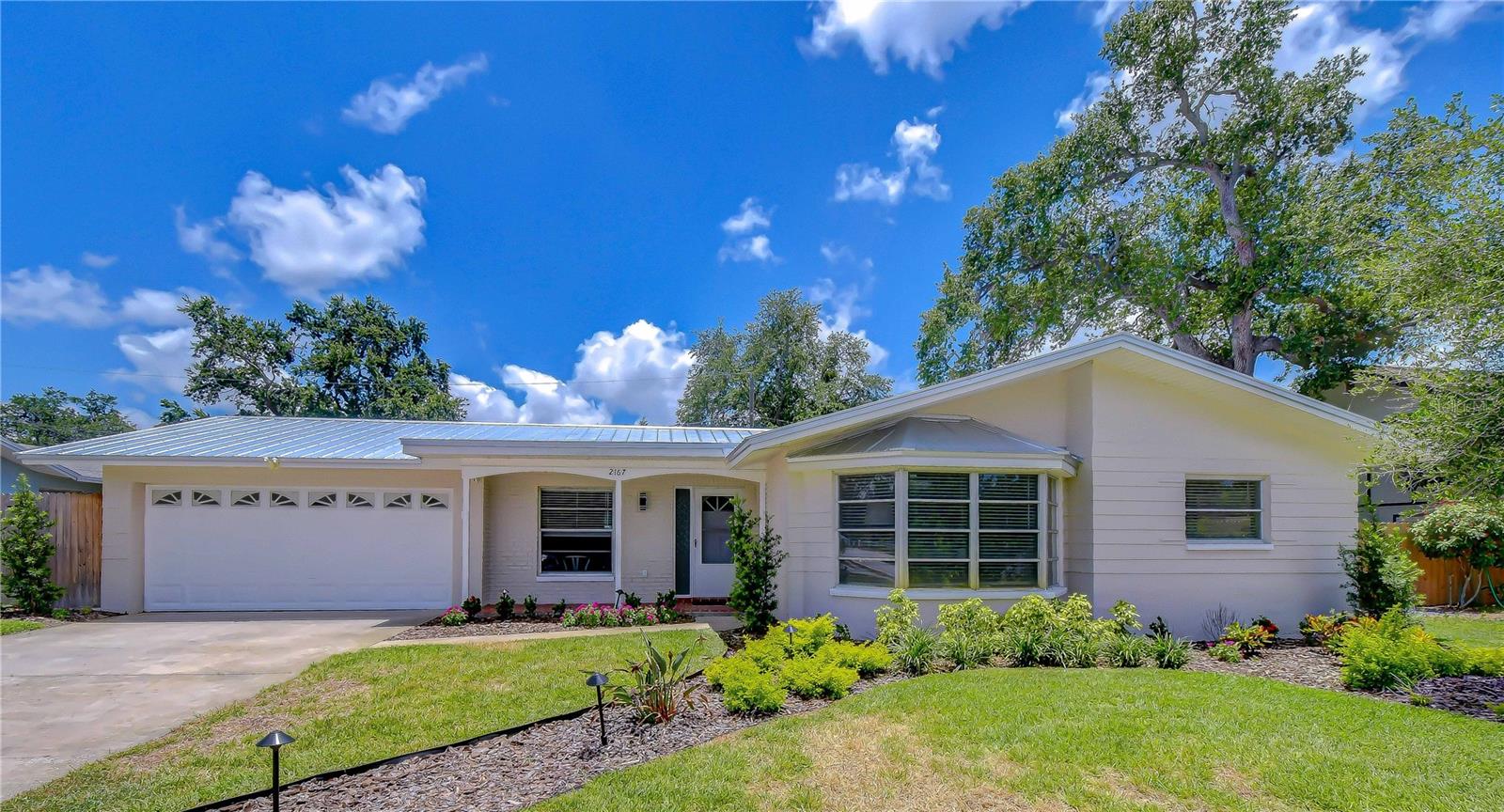 Welcome to Oak Grove Estates! This beautifully updated 4-bedroom, 2-bath ranch-style pool home with a dedicated office offers 1,686 square feet of comfortable, move-in-ready living. Inside, an open floor plan features luxury vinyl flooring throughout the great room, dining area and kitchen, with carpet in the bedrooms. The kitchen is designed for everyday living and entertaining with wood cabinetry, granite countertops, stainless steel appliances and a spacious island. Sliding glass doors open to an expansive covered lanai, pavered pool deck and large screened rectangular pool. The fully fenced backyard offers plenty of room for play, pets or a future fire pit area. The office/den/bonus area, located off the great room, includes a bay window that fills the space with natural light. The oversized primary suite features a walk-in closet and updated bath with wood cabinetry, granite vanity and walk-in glass shower. Two guest bedrooms share an updated bath with dual vanity and tub/shower combination. Additional highlights include a two-car garage with epoxy flooring and washer/dryer area. NEW ROOF June 2026 - POOL REFINISHED - NEW POOL SALT SYSTEM - NEW SPRINKLER SYSTEM W/RECLAIMED WATER - R30 INSULATION - NEW SLIDER & KITCHEN WINDOW. Oak Grove Estates is a Clearwater favorite, centrally located directly across from Allen Creek Park and Preserve, a peaceful hidden gem with walking trails, bird watching and abundant wildlife. Minutes from the Gulf beaches, boating, shopping, dining, Tampa International Airport, Downtown Tampa, St. Petersburg and major sports venues, this home is a wonderful opportunity to enjoy the best of Clearwater living.