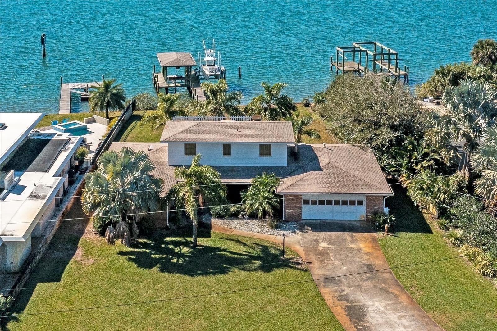 Home located on a quiet street with great direct views of the intracoastal.    Enjoy the warm breezes and sunsets from the back porch while viewing the natural landscaping over the river.  The view facing west will remain unspoiled.   The deep spacious lot accommodates  a 4 bedroom, 3 bath home with 2,570 square feet of living area.   Formal dining room/living room, eat in kitchen and family room with wood burning fireplace. Pella windows throughout home.  Plenty of space to store your fishing equipment in the work shop/tackle room with garage and outside access.  Deep water dock with water and electricity. ;Water: City