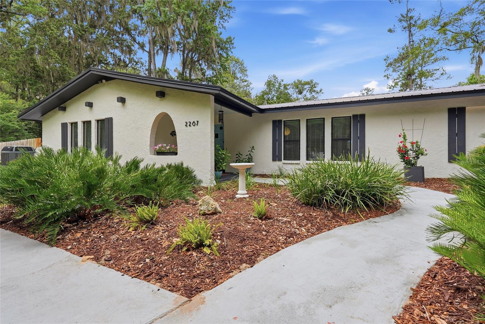Welcome to this beautifully updated home on a rare 0.88-acre lot backing directly to the 111-acre protected Serenola Preserve, offering exceptional privacy and a peaceful natural setting. Conveniently located near UF, Shands, shopping, and dining, this property combines the best of Gainesville living with the feel of a private retreat.

Inside, you'll find an expansive 280+ square foot heated and cooled sunroom, a spacious primary suite with a walk-in closet and updated bath, and a versatile air-conditioned bonus room ideal for a home office, gym, or potential flex space. The updated kitchen, fresh interior and exterior paint, and numerous recent improvements make this home truly move-in ready.

Major updates completed between 2024-2026 include a renovated kitchen and primary bath, full perimeter fencing, a new shed, irrigation upgrades, updated electrical switches and receptacles, and HVAC servicing. Additional features include a durable metal roof, double-pane vinyl windows, a high-efficiency dual-zone Trane HVAC system, updated appliances, ceiling fans throughout, and recently installed fiber internet on the street.

The beautifully landscaped property features mature fruit trees including orange, grapefruit, fig, mulberry, and loquat, along with majestic oaks, magnolias, and colorful flowering plants. With low utility costs, abundant outdoor space, and direct access to nature, this unique property offers a rare opportunity to enjoy privacy, comfort, and convenience in one exceptional package.