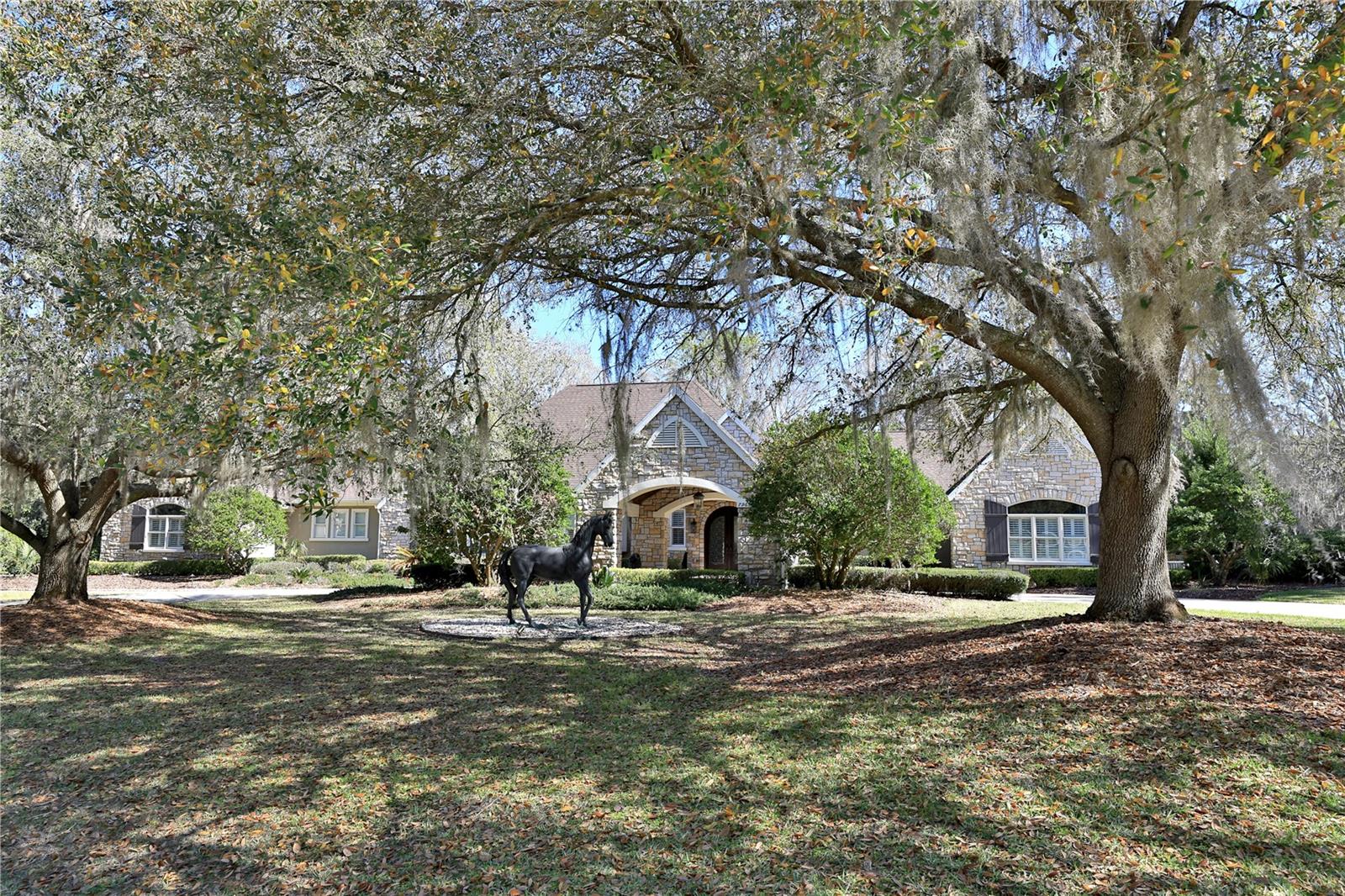 Elegant Entertaining Estate in the Country Club of Ocala. Set on more than two beautifully landscaped acres within the Country Club of Ocala, this exceptional residence offers refined French Country interiors, remarkable architectural details, and thoughtfully designed spaces ideal for everyday living and elegant entertaining. Upon entering, guests are welcomed by an impressive foyer that opens to a gracious living room filled with natural light. The open-concept kitchen and family room create a warm, inviting gathering space with expansive views of the eighteenth fairway of the golf course, the home’s spacious deck, and the sparkling swimming pool.
The chef’s kitchen is beautifully appointed with custom cabinetry, exquisite granite countertops, a large center island, and a raised bar with seating that seamlessly connects to the family room and outdoor entertaining areas. The dramatic family room features a striking black-stone fireplace, vaulted tongue-and-groove ceilings, Cypress beams, built-in cabinetry, and a private office accented with custom-designed iron doors. A versatile media room provides flexible space for a man cave, billiards room, or fitness area, with direct access to the luxurious owner’s suite. The spacious primary retreat includes a generous closet and dressing area, along with an elegant bathroom featuring dual facilities and a private laundry for added convenience.
Designed for effortless indoor-outdoor living, the screened pool area offers multiple spaces for dining, relaxation, and entertaining while enjoying serene golf-course views. Additional highlights include a spacious garage with a bonus area and ample storage.
Recent improvements enhance both comfort and peace of mind, including a newer roof, full-house generator, full-house water filtration system, four new A/C units, and a new central vacuum system complete with motor, tank, and hoses, all installed in 2021. Additional updates include a dishwasher, washer, and dryer in the primary suite laundry area, as well as a 36-inch Sub-Zero refrigerator/freezer with custom panels installed in 2023.
This remarkable property combines timeless elegance, modern updates, comfort, and exceptional entertaining spaces in one of Ocala’s most sought-after golf-course communities.