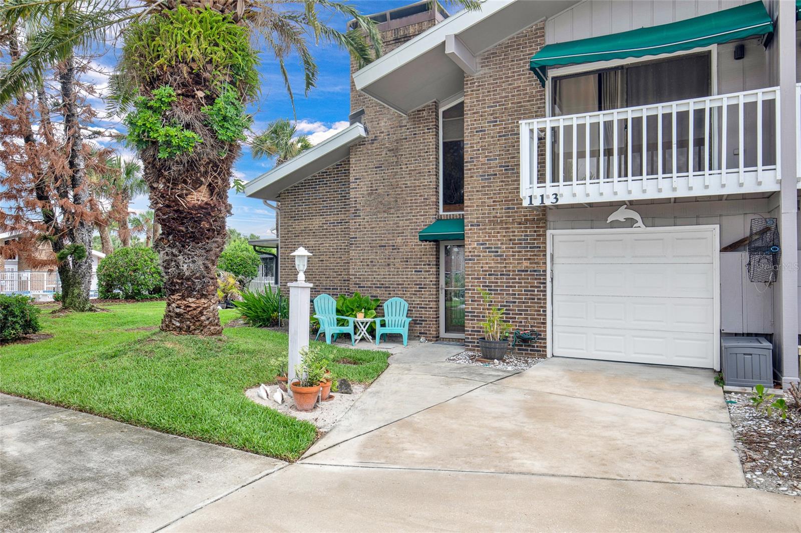 Welcome to Venetian Villas, a highly sought-after waterfront community ideally located just off the North Causeway and moments from the Intracoastal Waterway, Atlantic beaches, Flagler Avenue, popular restaurants, shopping, entertainment, and year-round local events. This beautifully maintained 2-bedroom, 2.5-bath townhome offers a spacious and inviting floor plan highlighted by soaring vaulted ceilings, abundant natural light, and a dramatic floor-to-ceiling brick fireplace that anchors the living area. The residence features an updated kitchen with stainless steel appliances, glass-front cabinetry, decorative backsplash, breakfast bar seating, and generous counter space, all flowing seamlessly into the dining and living areas—perfect for entertaining family and friends. The split-level design provides privacy and functionality, while the loft area overlooking the main living space offers flexibility for a home office, reading nook, or additional guest accommodations. Large sliding glass doors lead to a screened lanai and a lush side yard setting, creating an ideal space to relax and enjoy the coastal breeze. HOA benefits include lawn care and landscaping, irrigation, community pool maintenance, clubhouse, dock and waterfront common areas. Recent community improvements include new roofs, freshly painted exteriors, renovated pool facilities, and updated waterfront amenities. All measurements are approximate. Sq. footage received from the tax rolls. All information recorded in the MLS is intended to be accurate but cannot be guaranteed. Buyer should check zoning for rental restriction.