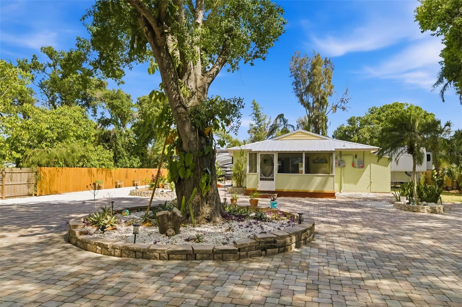 Opportunity, versatility and charm all come together in this beautifully maintained Sarasota County property on an oversized, fully fenced lot just over 1/2-acre! Featuring two bedrooms, two baths and multiple outdoor entertaining areas, this property offers endless possibilities for homeowners, investors or business owners alike with its multi-zoning potential allowing for commercial use, duplex possibilities and RV storage. Inside, you’ll find durable LVP flooring throughout, an open living room and kitchen layout, and a spacious kitchen featuring rich wood cabinetry, black Corian countertops, tile backsplash, and newer stainless appliances including a new dishwasher and refrigerator. The primary suite offers a walk-in closet, sliding glass doors leading to a private patio, and an en-suite bath complete with double sinks, soaking tub and separate shower. Home has new solar panels, which are transferable to a new owner at only $61 a month. Go outside and enjoy the shaded, treed property with multiple sitting areas, a fire pit, oversized lanai, storage shed, and plenty of room for RVs, toys or future expansion. City water and septic are in place, with the septic recently pumped and a newer drain field providing added peace of mind. Major updates include roof replaced 03/29/2023, windows replaced in 2023, solar panels installed 09/23/2025 and main electrical panel updated 12/09/2025. Air conditioner is 2005. Conveniently near the Orioles spring training facility, 17th Street Park, with baseball and BMX fields, the airport and downtown amenities, this unique property offers flexibility, convenience and incredible potential all in one package!