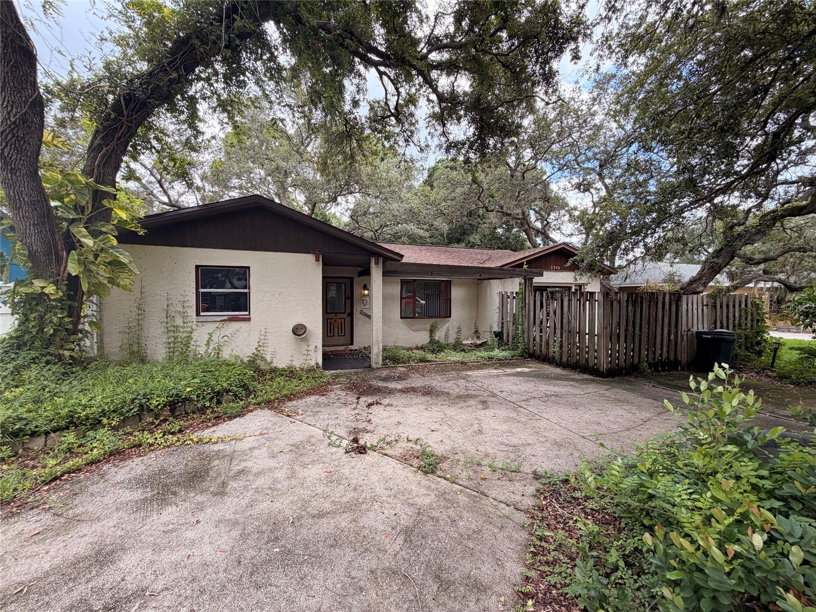 Welcome to Clearwater, where everyday convenience meets the laid-back Florida lifestyle. Centrally located in the established Gulf Breeze Estates neighborhood, this home offers easy access to shopping, dining, schools, parks, and major roadways, making it easy to reach Clearwater Beach, Downtown Clearwater, St. Petersburg, Tampa, and two international airports. Whether you enjoy spending the day along the Gulf Coast, exploring nearby trails and parks, or taking advantage of the area’s many entertainment options, this location places the best of Tampa Bay within easy reach.

Set on a generous 0.19-acre lot beneath mature shade trees, this 4-bedroom, 2-bathroom home is ready for someone with vision to make it their own. A 2025 roof provides an important head start, while the spacious layout and solid features offer plenty of potential for thoughtful cosmetic updates. Stepping inside, high ceilings create an open and airy first impression. The living and dining areas flow together comfortably, providing a flexible space for everyday living and entertaining.

The kitchen is in great condition and features abundant wood cabinetry, generous countertop space, stainless steel refrigerator, and a functional layout. The owner’s suite offers a walk-in closet, private ensuite bathroom, and sliding glass doors leading to the patio. Three additional bedrooms provide flexibility for family, guests, a home office, or hobby space. An enclosed patio offers additional room to relax and enjoy the surrounding greenery, while the dedicated laundry area provides extra storage and convenient access to the backyard.

Outside, the expansive backyard offers plenty of space to create your own outdoor retreat. With four bedrooms, a desirable floorplan, a brand-new roof, and a central Clearwater location, this home presents an exciting opportunity to update, personalize, and unlock its full potential.