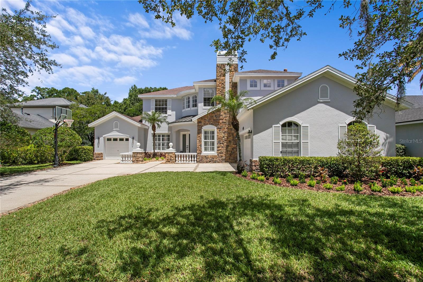 Set on over 2-acres in the highly sought-after Deer Creek community, this recently renovated 5-bedroom, 3.5-bath home offers a rare combination of comfort and sophistication. Boasting 4,373 sf of thoughtfully designed living space, the property is surrounded by mature landscaping and serene conservation views, creating a private retreat while remaining just minutes from Carrollwood’s premier amenities and schools.

Tastefully updated throughout, the home features crown molding, plantation shutters, and an exceptional floor plan designed for both everyday living and entertaining. The first floor offers formal living and dining rooms, along with an inviting family room that flows seamlessly into the kitchen. Designed to inspire both everyday meals and effortless entertaining, the kitchen showcases quartz countertops, stainless steel appliances, designer finishes, and a built-in workstation that balances style and functionality.

Designed for today’s lifestyle, the main level also features a spacious office/library with custom built-ins and glass French doors, creating a private space for working from home or quiet study. In addition, an impressive 16' x 30' great room offers flexibility for entertaining and everyday living. Anchored by a wood-burning fireplace, this inviting space includes a dry bar with a beverage refrigerator and opens through multiple French doors to the expansive screened pool, covered patio, and lanai, creating a seamless indoor-outdoor living experience. A private first-floor guest bedroom offers flexibility for overnight visitors or multigenerational living.

Upstairs, an open loft provides additional living space ideal as a study nook or secondary lounge. The primary suite features a tray ceiling, dual walk-in closets, a convenient morning bar with beverage refrigerator, and a beautifully renovated spa-inspired bath. Three additional secondary bedrooms share a well-appointed full bathroom with dual sinks, providing comfort and convenience for family and guests.

The outdoor living spaces are designed for entertaining, featuring a screened pool area overlooking the conservation setting. Completing the property is a desirable three-car garage configuration featuring an attached two-car garage and a separate one-car garage. Combining extensive renovations, an exceptional floor plan, and one of Deer Creek’s most desirable 2-acre homesites, this remarkable property presents a rare opportunity to enjoy refined living in one of Carrollwood’s premier communities.