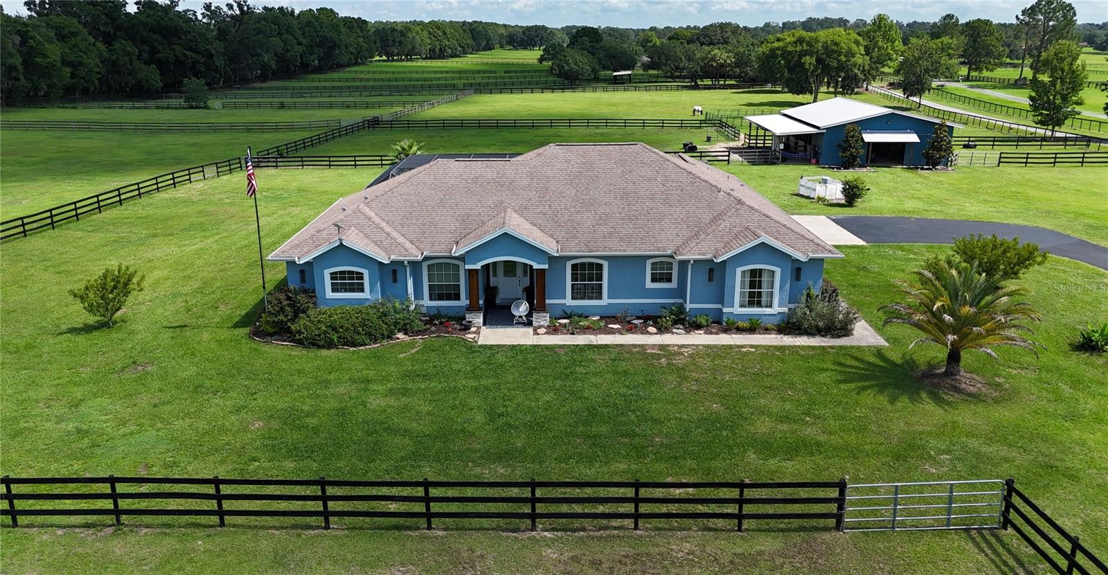 Beautiful 10-Acre Farm Minutes from World Equestrian Center
Located in the heart of Ocala’s renowned horse country, this picturesque 10-acre farm offers the perfect blend of comfortable living and equestrian functionality just 13 miles from the World Equestrian Center and 9 minutes from HITS.  A gated entrance and paved drive welcome you to the beautifully maintained property featuring lush green pastures, board fencing, and a well-appointed center-aisle barn.
The residence offers an inviting open-concept design with a spacious kitchen and living area ideal for everyday living and entertaining. A dedicated office provides the perfect work-from-home space, while the thoughtfully designed floor plan includes three bedrooms and three full baths.
Step outside to the screen-enclosed pool and lanai, where you can relax and enjoy peaceful views overlooking the barn, paddocks, and surrounding countryside. Whether watching horses graze in the pastures or entertaining family and friends, this outdoor living space captures the essence of Florida farm living.
The farm is thoughtfully laid out with beautiful fenced pastures and a quality center-aisle barn, creating an ideal setting for equestrian enthusiasts, hobby farmers, or anyone seeking a private country retreat.
Conveniently located near the World Equestrian Center, HITS, shopping, dining, and veterinary services, this turnkey farm offers a rare opportunity to enjoy the Ocala equestrian lifestyle in one of the area’s most desirable locations.