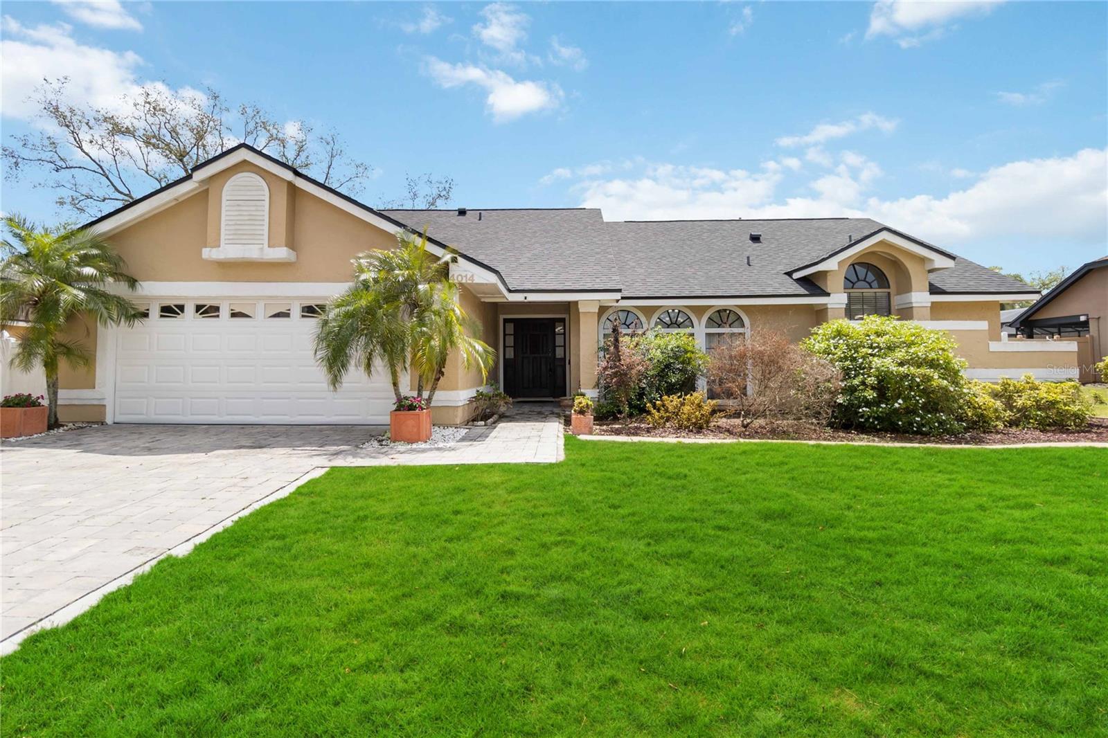 Welcome to 4014 Gallagher Loop, a stunning 4-bedroom, 2.5-bathroom retreat nestled in the highly sought-after Oak Park community of Casselberry that perfectly blends classic Florida charm with modern updates. Step inside to discover 2,247 square feet of living space defined by high cathedral ceilings, beautiful engineered hardwood flooring, and a sunken living room that offers a sophisticated gathering space. The heart of the home is a spacious family room anchored by a soaring brick-surrounded wood-burning fireplace and natural light, while the chef-inspired gourmet kitchen boasts sleek granite countertops, stainless steel appliances, and vibrant designer-painted accents. Retreat to the primary suite sanctuary, which features private lanai access and a spa-like en-suite bathroom with a garden bath and separate shower. The spectacular outdoor oasis serves as the true "wow" factor, offering a fully screened gunite pool, an extended covered lanai with dual fans for year-round BBQs, and a lush, vinyl-fenced 0.29-acre backyard. With essential updates including a 2021 roof, 2023 water heater, and 2024 AC Unit plus a prime location near top-rated Seminole County schools and Red Bug Lake Park, this home offers the ultimate lifestyle—schedule your private tour today!
