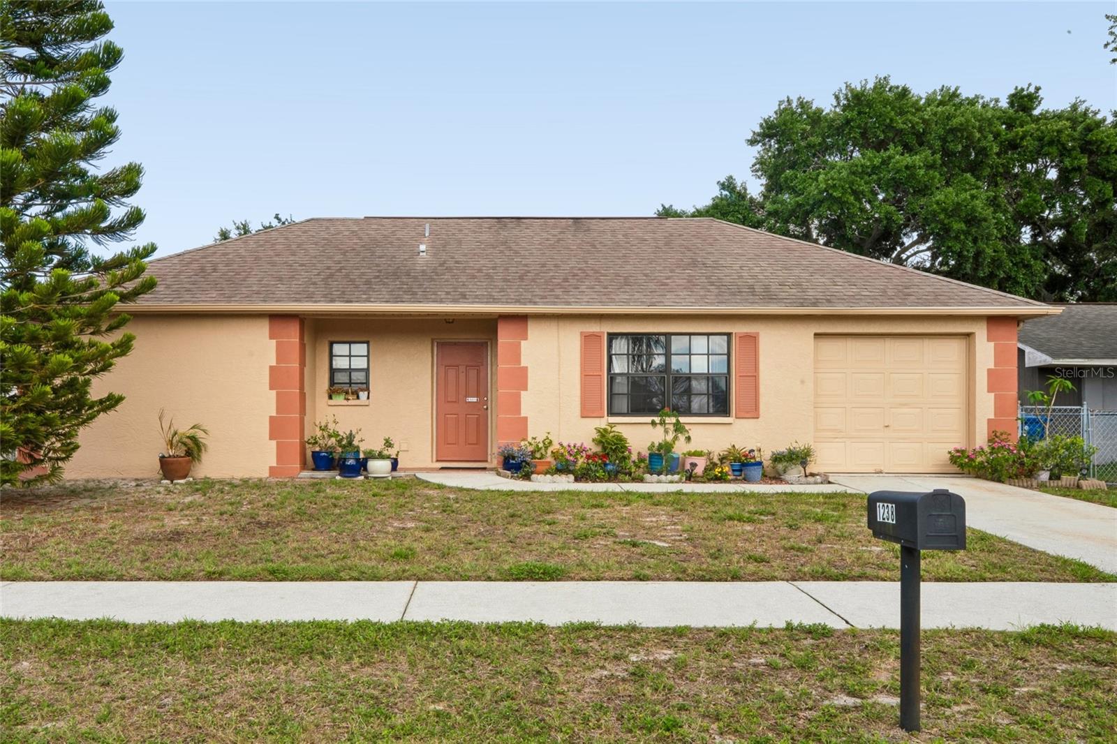 Available to homeowners as well as investors!  New to the market is an adorable and well maintained 2 bedroom, 1 bath home with an attached garage in Holiday Lakes West.  Seller will have a new roof installed with an acceptable offer.  And A/C system is from 2021. Sunroom has been drywalled in and adds additional living square footage.  Recent upgrades include a new SS refrigerator, new laminate flooring, new carpet, and fresh interior and exterior paint with interior doors replaced as well.  Spacious back yard to host family and friend gatherings, enjoy your hobbies, gardening, or let your furbabies enjoy the outdoors.  This home would make an ideal cozy and comfortable year round residence for the next chapter of your life, but it could also serve as a wonderful seasonal getaway.   And investors, yes, you can utilize this as an immediate investment property with no HOA restrictions.  Nor are there any CDD fees!  Property is in "X500" flood zone and seller has never experienced any flooding issues.  Utility companies are Duke for electric and PCU for water.  There is no shortage of shopping, dining, cultural events, outdoor activities, golf venues, amusement parks, sports arenas, beaches and scenic parks, boating options, the Pinellas Trail and more!  Proximity to two international airports, Tampa, Clearwater and St. Pete, as well as Lake Tarpon and the famous Tarpon Springs Sponge Docks.  Allow yourself to fall in love with the coastal, laidback lifestyle of Florida living.  Call to schedule your private showing today!  All information contained herein is deemed accurate, including leasing restrictions and approximate room measurements, but should be verified by buyer and buyer's agent.  NO SIGHT UNSEEN OFFERS WILL BE CONSIDERED.