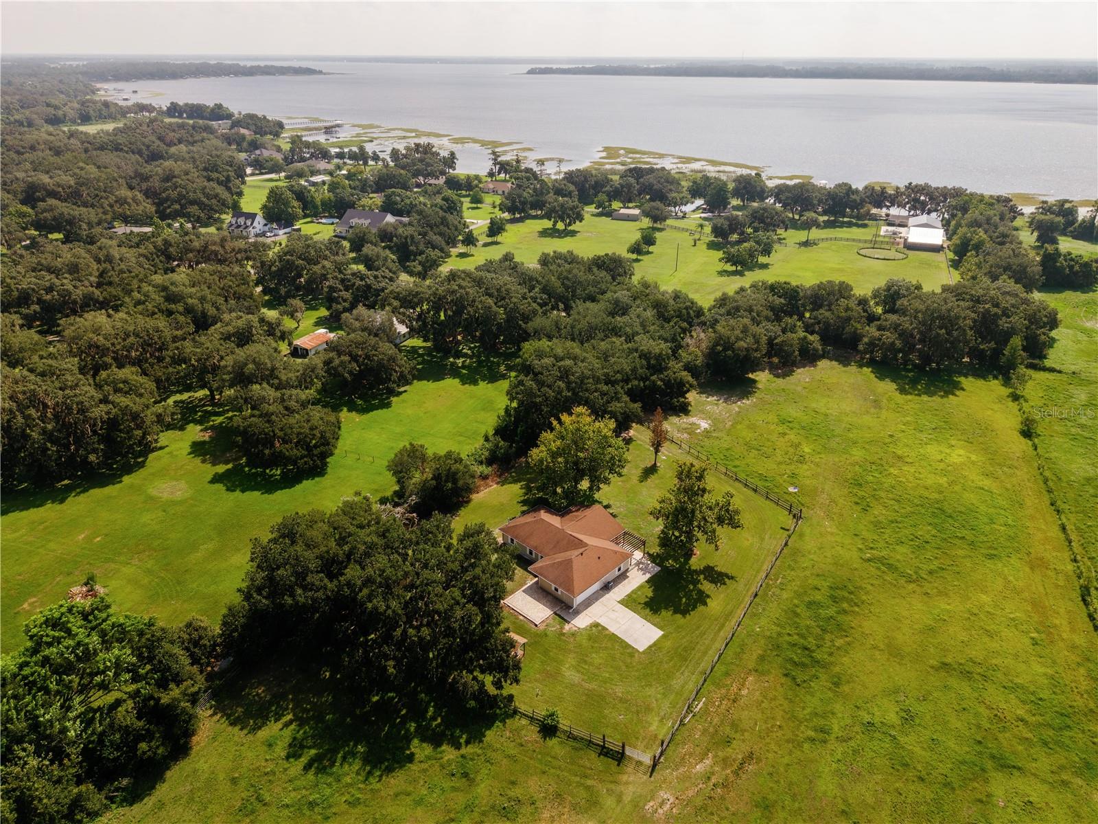 4.7 Acres with Ag zoning......BEAUTIFUL LAND, "HIGH & DRY", fenced & cross-fenced, A 300-YEAR OLD GRANDFATHER OAK, picturesque entry & bridge driveway. ROOF REPLACED 2018, WATER HEATER 2017, split floor plan, vaulted ceilings, marble sills, SIDE-ENTRY GARAGE, GUTTERS. Huge FLORIDA ROOM with multiple windows and a STUNNING panoramic view of the property......create a cozy TV space & still have LOTS of space for a desk area or crafts station.  We have an inside Laundry Room with a utility sink & cabinets.  Double closets in the Owner's Suite with a PERFECT FOOTPRINT FOR A SPACIOUS WALK-IN DREAM CLOSET. There are TWO hall storage closets, the front AND back entries both have glass storm doors.  Our back lanai has pavers and an ornate pergola......hang a swing, install screen, & create a relaxing paradise in the shade of the mature Sycamore trees.  A large storage shed comes in handy for yard tools, animal supplies, or equipment.....partnered with a "lien-to", it keeps the mower of out the weather.  This property is IDEAL for pasture.....horses, cows, goats, etc.  Want family nearby??  Use this current residence as an "in-law" home and build a larger home only steps away.  Westshore Drive is known for its MAJESTIC OAK canopy, the attractive custom homes, refreshing nearby lake breezes, & the quietness of a no-outlet street.  Land to park the trailers, RV's, boats, and more.  Build a chicken coop, bring the pups, plant a garden, design the workshop you've always wanted, watch the horses run, enjoy the many birds, & have a SUPER location.......Melbourne Beach is within 49+ miles, Lake Nona is within 18+ miles, Orlando International Airport is within 20+ miles, downtown St. Cloud is within 7+ miles.  Grocery, medical, shopping, & delivery services are all available......fiber is being installed in the area and should be in soon for the folks who work from home.  Welcome to 3430 Westshore Drive, come take a peek, you're "Almost Home".