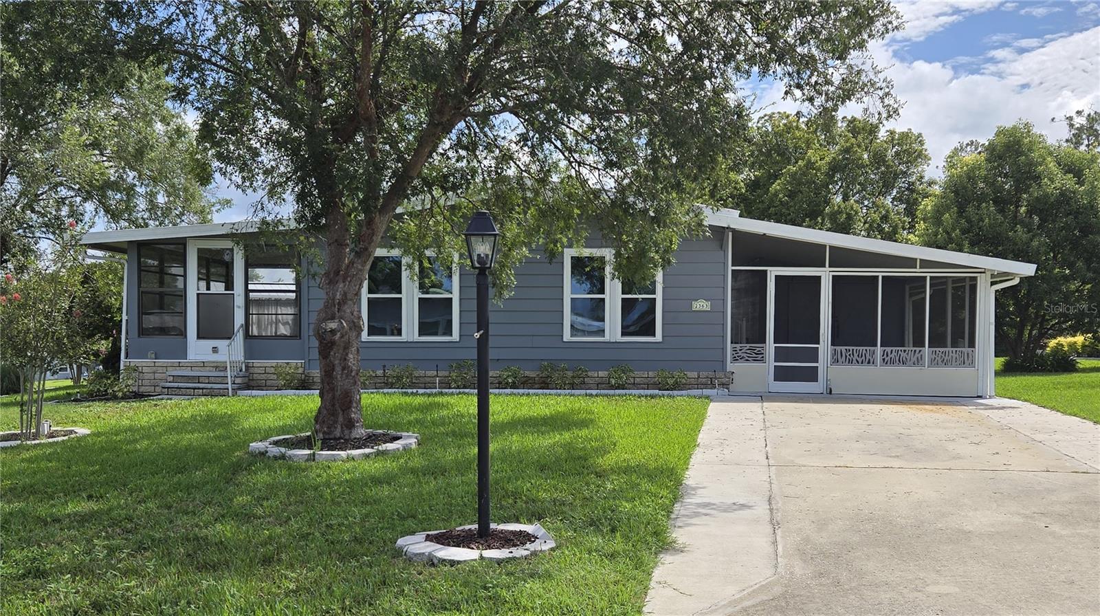 Fully renovated home on land owned corner lot in Banberry Village.   2BD, 2BA. 2363 S Citrus Circle 1050 sf + 150sf Florida Room. Land Owned, Pet Friendly, 2 Bedroom, 2 Bath home on a beautiful corner lot. This home has been totally renovated and is move in ready. Interior walls, trim, and doors painted 2026. NEW in 2024 - Screened in carport with 3 doors – front, back, and vehicle access door. NEW in 2023 – widened 2 vehicle driveway, 14’ x 12’ back patio. NEW in 2023 & 2024: Landscaping front, side, and back. 

NEW in 2022:  Membrane Roof over Metal, Addition to Shed with Sliding Barn Doors, Vapor Barrier, Insulation, Duct Work, Plumbing in both bathrooms, Walk-In Tiled Shower, Free-Standing Soaker Tub, Tall Toilets, ¾” Plywood Subfloor, 5/8” Luxury Vinyl Flooring, Drywall , Electric Range, Dishwasher, & Microwave Oven (refrigerator is not new, but in excellent condition), Kitchen Island, Quartz Countertops, Double Hung Tilt-Out Vinyl Windows (except in Florida Room), Ceiling Fans and Light Fixtures, Freshly Painted Ceiling, Six Panel Interior Doors with Lever Hardware, Culligan Whole House Water Softener, Window AC Unit in Florida Room.

This beautiful home can be yours while you enjoy all the amenities of Zellwood Station; including 18 Hole Golf Course, 4 Swimming Pools (1 Heated), Hot Tub, Exercise Room, Activity Rooms, Club House, Restaurant, Greenhouse, Library, and more.  Cable TV and Internet are included in the HOA fee.