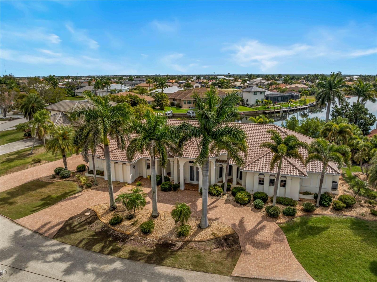 Situated on a rare double lot in the highly sought-after Punta Gorda Isles waterfront community, this custom-built, single-story residence offers an exceptional blend of space, luxury, and boating convenience. With 4 bedrooms and 3.5 bathrooms, the thoughtfully designed layout provides generous living areas ideal for both everyday comfort and entertaining. The heart of the home is the large, well-appointed kitchen, offering ample counter space, abundant cabinetry, and an open flow into the main living and dining areas—perfect for gathering with family and friends. Step outside to an expansive lanai and outdoor living space designed to capture the best of Florida living. Enjoy a self-cleaning pool and spa, along with a fully equipped outdoor kitchen, creating the ultimate setting for relaxing or hosting guests year-round.
Boaters will appreciate the **quick access to open water—just a couple minutes by boat—**making spontaneous days on the water effortless. Inside, hurricane impact windows and doors provide both peace of mind and energy efficiency.
Spread across two oversized lots, the property offers additional privacy, extra yard space, and a rare sense of openness not often found in waterfront homes.This exceptional Punta Gorda property combines custom craftsmanship, expansive indoor-outdoor living, and premier boating access, delivering the ideal Southwest Florida lifestyle. The roof was replaced in 2024 and just got a new water heater. The dock has tide slides and has been dredged to accommodate larger boats w 85' of dock. The Decor built in-fridge was recently added.