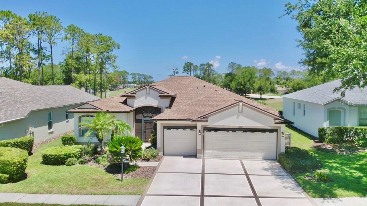 GOLF COURSE VIEW in the popular 55+ gated golf community of Heritage Pines.  Offered FURNISHED OR UNFURNISHED.  With 4 bedrooms, 3 full baths, + 3-car garage this home offers over 2200 sq. ft. of  comfortable living space. Architectural enhancements include crescent window, high ceilings, plant shelves & archways.  Upon entering the home through the screened front porch with glass front door you’ll have an unobstructed view of the golf course from the combination formal living room / dining room with sliders leading to the lanai.  Just beyond  is the open dinette area and kitchen overlooking the family room with lots of natural light. Meal prep will be a breeze in the full appointed kitchen complete with breakfast bar, all appliances, disposal, built-in desk, abundant 42” cabinets, recessed lighting, & double door pantry filled with roll-out shelves. The primary suite with tray ceiling & access to the lanai has 2 walk-in closets and an en-suite bath complete with dual sinks, WALK-IN TUB, walk-in shower, and private toilet. With a split bedroom plan providing lots of privacy & multi-generational living possibilities,  bedrooms 2 & 3 near the front of the home share bath with tub/shower combination.  Bedroom #4 at rear of home with additional access to the lanai  has its own bath with a shower.  Very functional laundry room including washer / dryer / laundry tub / + cabinetry for storage. The screened lanai with tile plank flooring was extended to not only provide shaded seating area, but also room for relaxing in the sun. GENERATOR 2024. ROOF 2024. A/C 2015. Sinkhole remediation completed in 2013.  All docs available. You’ll find endless resort style amenities at Heritage Springs including clubhouse, community pool, fitness center, library/computer room, golf shop, tennis, bocce court, golf course, horseshoes, spa facilities ….. just to mention a few.  Shopping, dining, & medical options close by. And with easy access to the Suncoast Parkway, you’re only a short drive to all that the Tampa Bay area has to offer.  Call for your private showing today and start enjoying the Florida lifestyle!