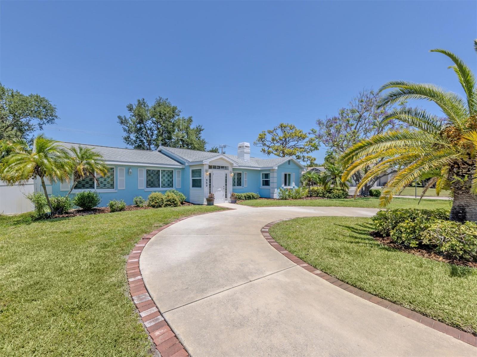 Welcome to this beautifully updated three-bedroom, three-bath, pool home on the desirable Island of Venice, just minutes from charming downtown and moments away from nearby turquoise Gulf beaches. Fully renovated throughout (effective date 2012), this meticulously cared-for residence offers the perfect blend of luxury, comfort and coastal living. Major updates include a new roof (2019), replumbing (2020), impact-resistant windows (2025), French doors, sliding doors and garage also impact resistant, dual air-conditioning units, updated pool and spa, new screening, irrigation system (new well pump), backup generator and lush landscaping (see attached full list of updates). The elegant oversized neutral tile flooring and stylish finishes in this home create a bright, timeless feel throughout. A circular driveway and welcoming double-door entry lead into an impressive interior boasting high ceilings and spacious living areas designed for entertaining. The stunning great room features a wet bar with an ice maker and French doors opening to your private tropical retreat, complete with a large screened-in saltwater pool and spa area with cool-touch non-slip decking, serene gardens and a dedicated grilling area, ideal for entertaining year-round. The thoughtfully designed layout includes a cozy sitting room with a wood-burning fireplace, leading to the private guest wing with two bedrooms and a lovely updated full bath for the best of family and friends. The renovated gourmet kitchen features granite countertops, stainless steel appliances, soft-close cabinetry and elegant under- and over-cabinet lighting. The breakfast/snack bar is ideal for a quick cup of coffee or a great spot to nibble on delicious appetizers for that perfect gathering of friends. The oversized primary suite offers pool views, a luxurious en-suite bath with skylights and an adjoining office/exercise bonus space. Additional highlights include a spacious laundry room with an extra refrigerator, abundant cabinetry and a door leading to the pool. The oversized two-car side-entry garage with room for a golf cart and workshop completes this picture of utter comfort. Island living, fabulous condition and great value; this home has it all! Schedule your private showing today.