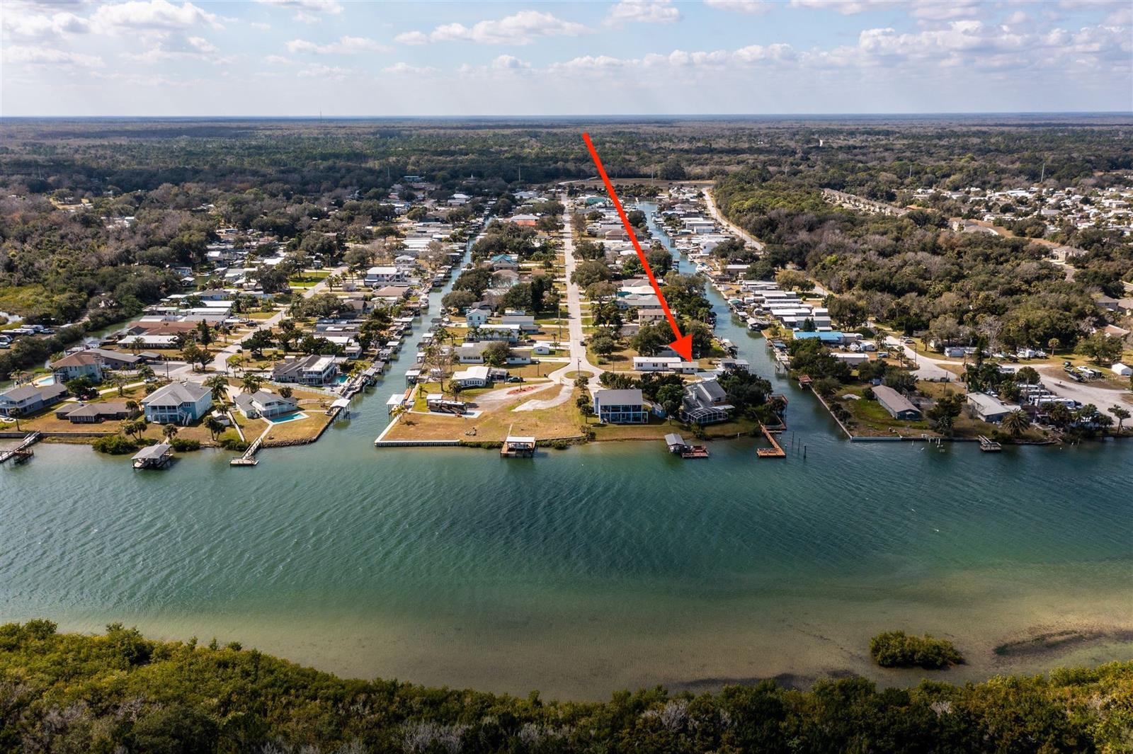 Amazing location 3rd house from intracoastal waterway! Catch the river breezes along with plenty of fish and shrimp as you enjoy the waterfront lifestyle this property offers.  Build your dream home here on this deserving lot or enjoy "as is" and make the 3 bedroom 2 bath manufactured home to your liking.  There is a concrete block garage/workshop, new dock , covered 5,000lb boat lift , entertaining bar dockside with a secure storage area and a good sized patio. Explore the Indian River Lagoon from your backyard. ;Water: City