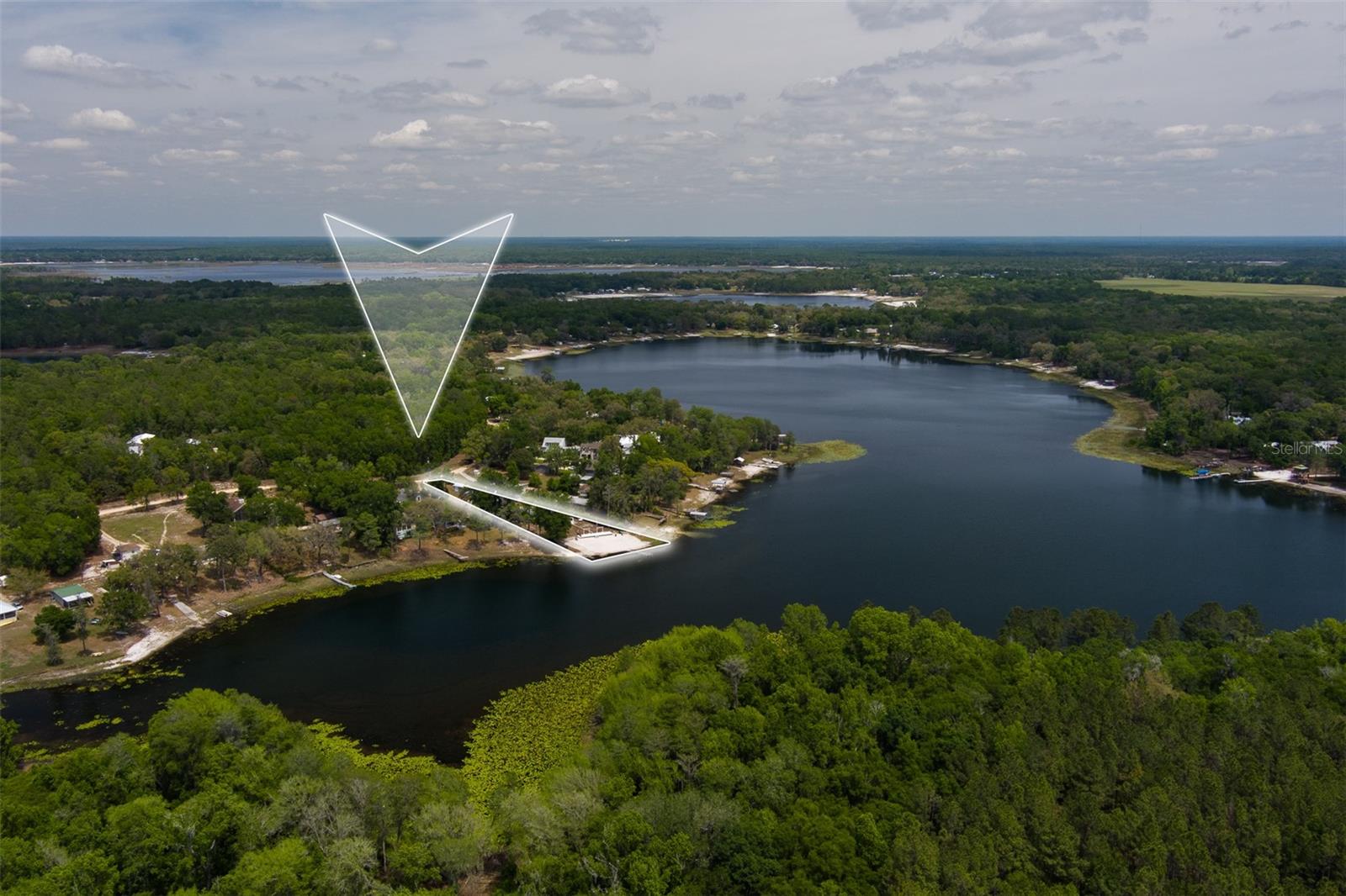 Tucked along the pristine shores of Lake Lily in Melrose, this exceptional waterfront retreat offers a rare blend of natural beauty, recreation, and versatility. Known for its crystal-clear, spring-fed waters, Lake Lily is one of the area’s most sought-after lakes—large enough to accommodate water skiing, jet skis, and a full range of water sports, yet peaceful enough to enjoy quiet mornings and breathtaking sunsets.

The approach to the property is as memorable as the home itself, with a scenic drive winding past picturesque horse farms and open countryside that immediately sets a tone of relaxation and escape. Situated on a quiet road with very little traffic, the setting provides a sense of privacy and calm that is increasingly hard to find.

This well-maintained 4-bedroom, 2-bath home is thoughtfully positioned to capture stunning lake views from multiple vantage points. Inside, you’ll find a beautifully updated kitchen designed for both functionality and style, seamlessly flowing into the main living areas. The expansive sunroom is a true highlight, featuring walls of windows that frame panoramic views of the water—perfect for relaxing, entertaining, or simply taking in the serene setting year-round.

Step outside and experience the ultimate lakefront lifestyle. Two oversized decks overlook the water, offering ample space for dining, entertaining, or unwinding in the fresh air. A sandy beach provides the perfect spot for swimming or lounging, while your private boat ramp makes it effortless to launch and enjoy a day on the lake.

The property is as functional as it is inviting, featuring a 2-car detached garage, a large metal building for storage or hobbies, and a detached guest suite with a half bath—ideal for visitors, extended family, or a private workspace. A separate utility building with shower and laundry adds convenience, especially after long days spent on the water.

Beyond the property itself, a true sense of community sets this home apart. Friendly neighbors and cherished traditions create a welcoming atmosphere, including annual fireworks displays over the lake on the 4th of July and New Year’s Eve—an unforgettable experience right from your own backyard.

For added convenience and a true turnkey opportunity, all furnishings, pool table, and even the boat and jet ski may be included with an acceptable offer.

Whether you’re looking for a full-time residence or a private getaway, this property delivers the best of both worlds—an active waterfront lifestyle paired with the tranquility of a true retreat. Surrounded by natural beauty and set on a premier recreational lake, this is where lasting memories are made.