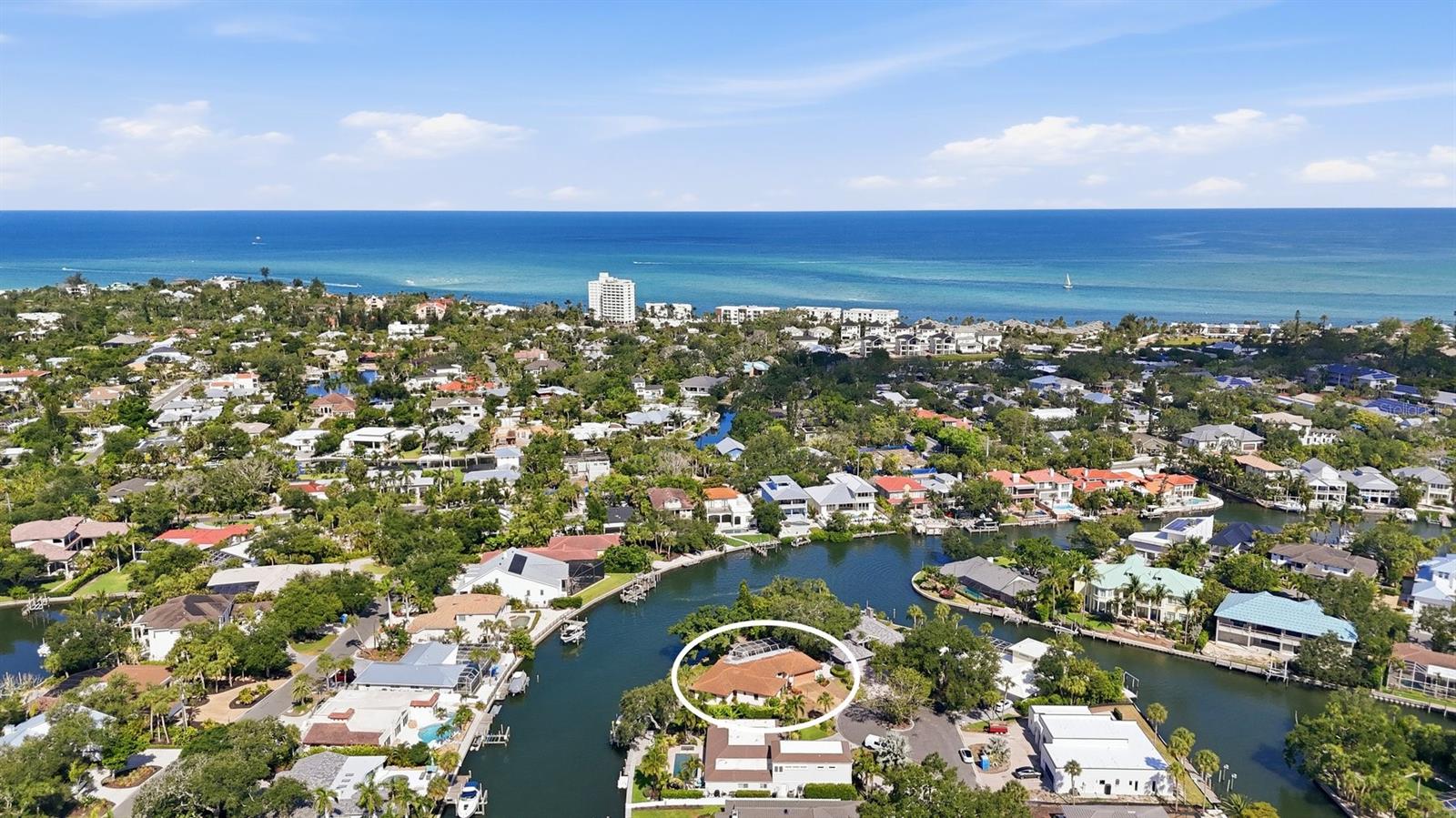 Rare GRAND CANAL redevelopment opportunity on Siesta Key, offered at land value. This estate-sale homesite delivers approximately 168 feet of water frontage — among the most generous on the Grand Canal — along one of the canal's widest, most open stretches, with long water views and exceptional ease of egress. Boaters enjoy quick passage to the Intracoastal Waterway and on to the Gulf, with the bridge just minutes away. Tucked on a peaceful cul-de-sac, the site pairs privacy with proximity: a short bike ride to the powdery white sand of top-rated Siesta Key Beach. Build anew and capture full water views, or renovate to your vision. While the primary value is the exceptional lot, per seller, water has not intruded the interior of the existing home. Sold at land value, buyer to perform all due diligence. Opportunities of this width, frontage, and location on the Grand Canal are exceedingly rare.