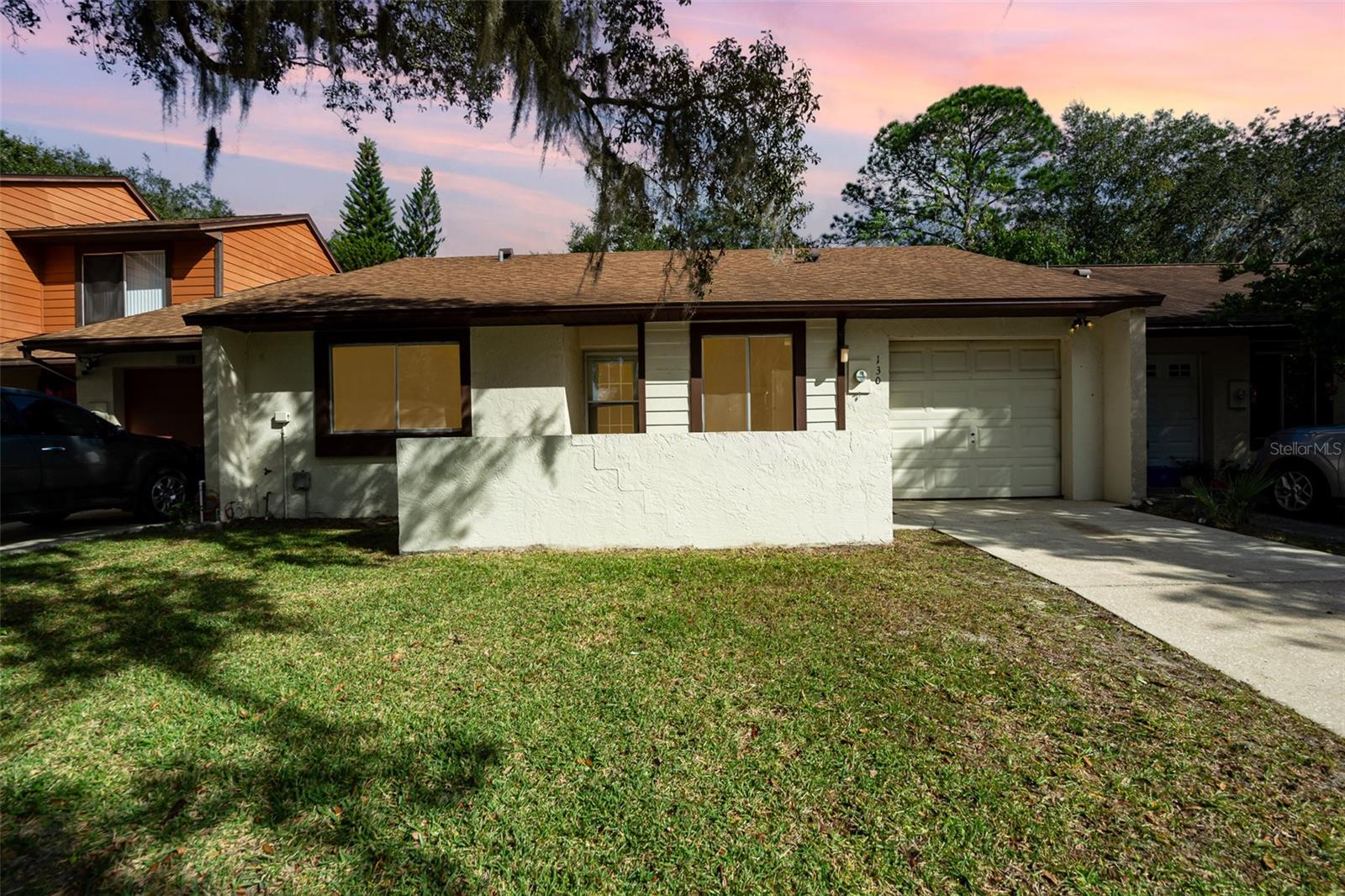 ADORABLE-AFFORDABLE! ***$10,000 Closing Cost Allowance with Full Price Offer*** Begin home "OWNERSHIP" here in this updated villa in Sanford's serene Hidden Lake community. Located on a quiet cul-de-sac, this 2BR/2BA home features open concept living and a convenient 1-car garage. Just beyond the front door, brand new luxury vinyl flooring and freshly painted walls set the stage for stylish living. A slight pivot from the foyer takes you to the spacious kitchen with updated appliances and bar seating. With vaulted ceilings and fireplace-as-centerpiece, the living room is a showstopper! The primary bedroom suite is perfectly sumptuous with its own bathroom and gentle views of the lush backyard greenery. A roomy second bedroom and full bath complete the indoor living area. As for outdoor living, you can enjoy the options of a cozy screened porch or fenced yard overlooking preserved nature. Benefits of this villa include pool, tennis court, playground, and park access. Roof is 2018. AC is 2021. Make a New Year's Resolution--TO OWN YOUR OWN HOME!