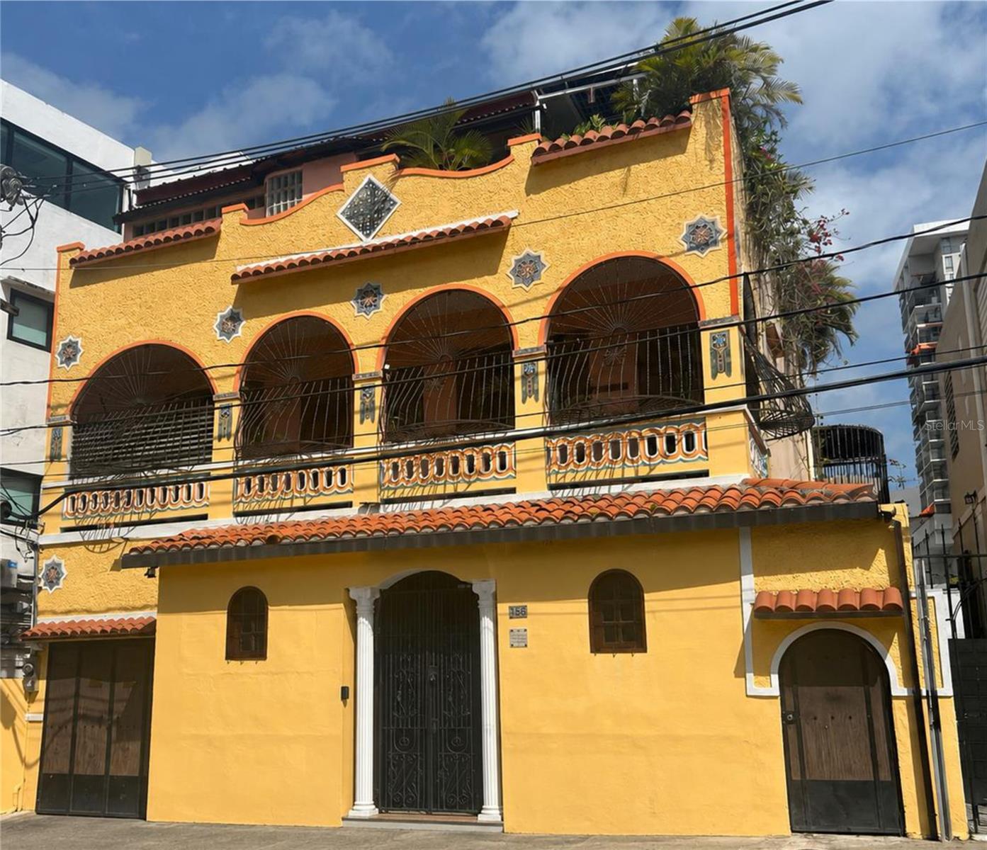 This is one of the most unique houses in the Santurce Arts District of San Juan - only two short blocks from Ciudadela, 24 hour supermarket, 24 hour Planet Fitness and the Parque de Santurce. 
The owner has retained the 'single family' layout as a grand residence - but also designed 'lockout' units that can be combined as residential, commercial, short term rental, or any combination since it has a special Santurce Zoning category that allows almost any use.

Originally built as a single-story house in 1915, the house was expended with two floors after the trolly lines brought development along Ponce de Leon Avenue and 'Parada 24' in the 1920's. Note the original 'Santurce Mosaics' that are emblematic of the era.
There were only two owners prior to the current renovation - so it still has original details. From the original building, you'll find museum-quality 'creole tiles' on the first floor. The expansion added an Art Deco beam to the first floor living room and a fantastic Art Deco stairway with classic terrazzo tiles. As a bonus, they retained some of the original 'creole' tiles on the 2nd floor's full-length balcony.

First Floor:  Entry foyer leading to formal living room with half bathroom that also has the solar battery/inverter. There is a garage/work room with 'wet room' bathroom and the washer/dryer. The stairway to upper floors is an Art Deco classic.  The semi-covered 'gazebo courtyard' has an 'indoor/outdoor' kitchen on one side and a 'casita' guest suite on the other side with king bed and ensuite bathroom - perfect as an 'in-law' suite or short term rental since it has a private entrance. The half bathroom in the great room also has the solar battery/inverter and a separate utility sink closet. The main space or 'great room' is very flexible and French doors can be opened to extend the space to the side terrace and the courtyard of the 'in-law suite'.  It has been used for events with up to 100 guests.

Second Floor: Landing/lobby/dining room with door to the ront balcony. Full kitchen with door to the front balcony. An arch from the kitchen to the dining room has panels that can be closed to reveal a mural by local artist Sarah Urbain. Full bathroom. Two bedrooms that accommodate king beds.  Back deck/living area with covered and open areas that are fully secured.

3rd Floor Penthouse: Designed as an 'urban oasis suite' with large bathroom, walk-in closet, kitchenette, living room and bedroom that accommodates a king bed. French doors lead from the living room to an outdoor dining area and gardens plus an outdoor living room beneath the solar panels.

The house is located in special Santurce zone ZU-G3 which allows residential, commercial or combined use.  Property is not in a historic district or zone so does have restrictions on renovation.  

Public transportation: Bus stop at the corner for Miramar, Old San Juan, Condado, Urban Train, Hato Rey, Plaza las Americas, etc.  Bus stop 2 blocks for Convention Center District.  Walk to Ocean Park Beach - 2,000 steps or about 12-15 minutes. This is a great 'walkable' neighborhood so you easily live without a car. The Santurce Arts District has the highest concentration of cultural venues in the Caribbean.  Mauro Ballet School is behind the house, Bellas Artes Fine Arts Center is 3 blocks away and museums, theaters, galleries and more are within a few minutes walk.