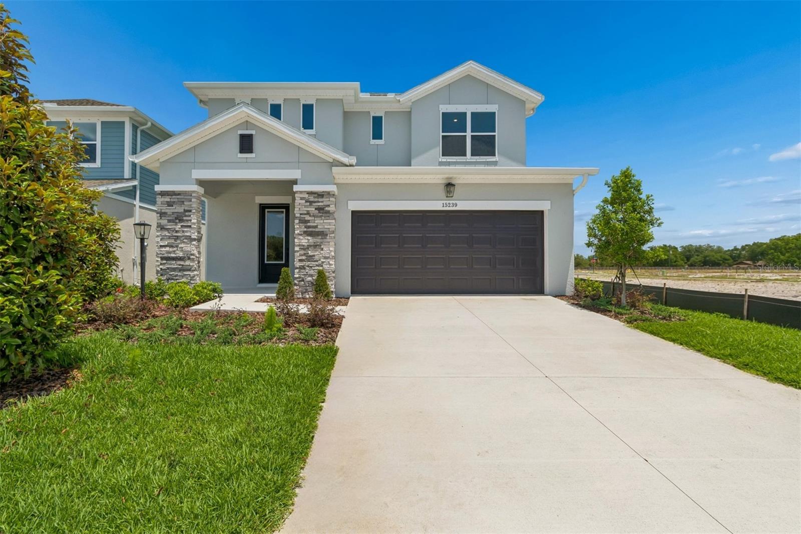 Discover the Zander by David Weekley Homes at Eastlyn in Bradenton, FL, Just ten minutes from I-75 and SR 64 you'll find a two-story home beautifully designed for you, where modern elegance meets everyday functionality. With no CDD Fees and low-HOA, Eastlyn provides a peaceful setting that's close enough to the highway to be convenient, yet far enough away to avoid the big city traffic. Only a 4-minute drive from groceries, 10 minutes to the Costco/Target shopping center where you'll find a variety of stores and top restaurants. Easy access to Sarasota, St. Petersburg, and Tampa allow you to enjoy big city amenities when you want them and the serene relaxation when you don't. This spacious floor plan offers 4 bedrooms, 3.5 bathrooms, 2 car garage and a large upstairs retreat that can serve as a game room, home theater, or quiet reading nook and is backed by David Weekley Homes' comprehensive 1-2-10 warranty. The gorgeous kitchen is a showstopper, featuring quartz countertops, a large walk-in pantry, and seamless flow into the open-concept dining and family areas. Outstanding use of windows and natural light in the atrium style main living area enhances the luxury throughout and adds an elegant feel. The Owner’s Retreat provides a private escape with a spa-inspired walk-in Super Shower, and a spacious walk-in closet. The flooring choices throughout are sure to please with durable laminate flooring running through the main living spaces, blending style with practicality and tile in the bathrooms and carpet in the bedrooms. Step through the backdoor onto the large lanai and you've found the perfect place for morning coffee or evening conversations under the Florida sky. **This property offers a limited-time interest rate incentive.