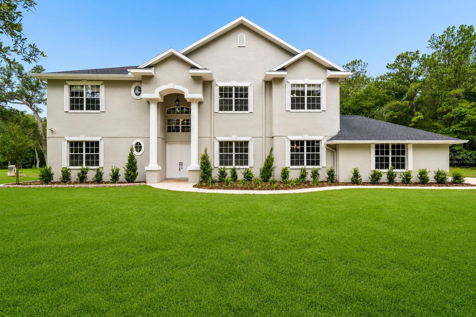 Virtually Staged. Welcome to your own private estate in Brooksville, Florida. Nestled on more than 8 beautifully wooded acres, this custom-built 5-bedroom, 4-bathroom pool home offers the perfect combination of luxury, privacy, and room to live the country lifestyle you've been dreaming of. Tucked away on a quiet private road, this exceptional Hernando County property is surrounded by mature trees, creating complete seclusion while remaining just minutes from shopping, dining, and everyday conveniences.
Designed with both entertaining and everyday living in mind, the home showcases soaring 25 foot ceilings, an impressive two story family room, abundant natural light, and an open floor plan that creates a grand yet welcoming atmosphere. Fresh interior paint, updated mechanical systems, upgraded HVAC units, and a newer roof provide peace of mind and move-in-ready convenience.
The spacious kitchen is the heart of the home, featuring granite countertops, a large center island with a unique natural-edge granite surface, built-in oven, cooktop, oversized pantry, breakfast bar, and an expansive dining area overlooking the backyard. Multiple sets of French doors seamlessly connect the indoor living spaces to the outdoor oasis.
The first-floor primary suite is a true retreat with private pool access, a spacious walk-in closet with convenient laundry room access, dual vanities, a soaking tub, oversized walk-through shower with dual shower heads, and peaceful views of the surrounding property. A second downstairs bedroom with an adjacent full bath makes an ideal guest suite, home office, or multigenerational living space.
Upstairs offers three additional oversized bedrooms, two full bathrooms, beautiful wood flooring, a dramatic catwalk overlooking the living area, and an enormous bonus room perfect for a media room, game room, home gym, or additional family living space. An upper-level covered balcony provides elevated views of the pool and surrounding acreage.
Step outside to your resort-style backyard featuring a heated swimming pool, oversized spa, expansive paver deck, covered lanai, sun shelf, and endless privacy. Towering oak trees provide shade and create the perfect setting for relaxing or entertaining year round.
With over 8 acres of mostly dry land, this property offers exceptional flexibility for horses, livestock, recreational vehicles, workshops, barns, gardens, or future expansion. Whether you're searching for an equestrian property, hobby farm, private family estate, or simply room to spread out, this rare Brooksville acreage delivers endless possibilities.
If you've been searching for a custom pool home with acreage, privacy, modern updates, and space to create the lifestyle you've always wanted, this one-of-a-kind Brooksville property deserves a place at the top of your list. (ROOF-2026)(A/C-3 units-2 are 2022,1 is 2007)(W/H-2025)(SEPTIC-NEWER TANK)