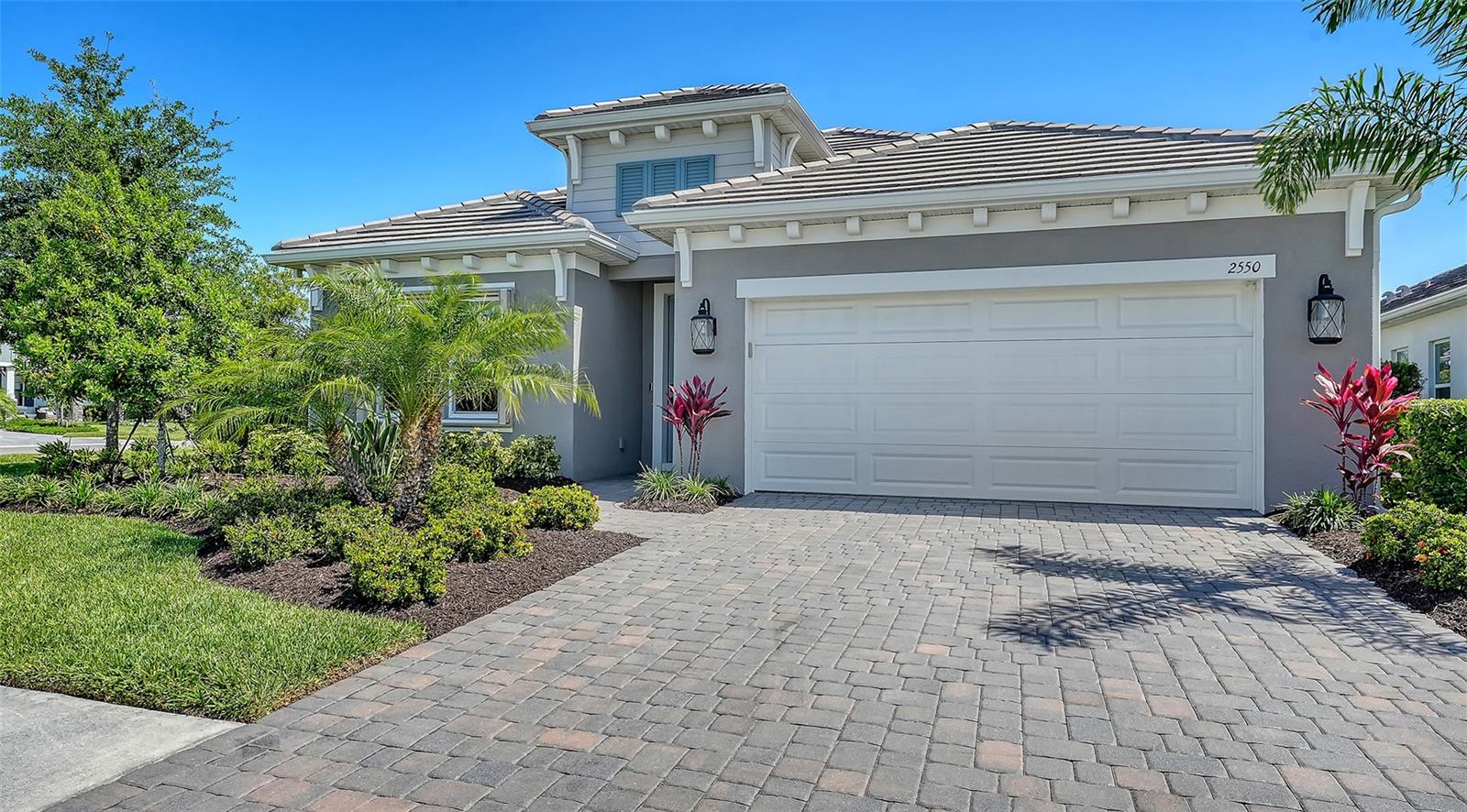 The best one-story value in Windward under $1M - on a coveted corner lot with room to add a pool— Welcome to 2550 Wild Cherry Path, a 3 bedroom, 3 bath + den Triumph model with 2,334 square feet of thoughtfully designed living space in one of Lakewood Ranch’s most sought-after and amenity-rich gated communities. From the moment you arrive, the tile roof, paver driveway, and mature landscaping create a warm, inviting first impression. Inside, the open layout is bright and functional, featuring 9-10 ft tray ceilings, wood-look tile flooring, and a seamless flow between the great room, kitchen, and dining area. The kitchen is well-appointed with gas appliances, a large island, generous cabinetry, and a walk-in pantry. The primary suite is spacious and private, with room for a sitting area, two large walk-in closets, and a well-designed bath with dual vanities and a walk-in shower. Two additional bedrooms and bathrooms provide flexibility for guests or family. The screened and covered lanai is built for Florida living, complete with an outdoor kitchen and additional remote electric screen for comfort and protection. Windward offers a true resort lifestyle with two pools, fitness center, pickleball, dog parks, playground, and a full-time lifestyle director. Just minutes to Waterside, top-rated schools, and everything Sarasota has to offer.