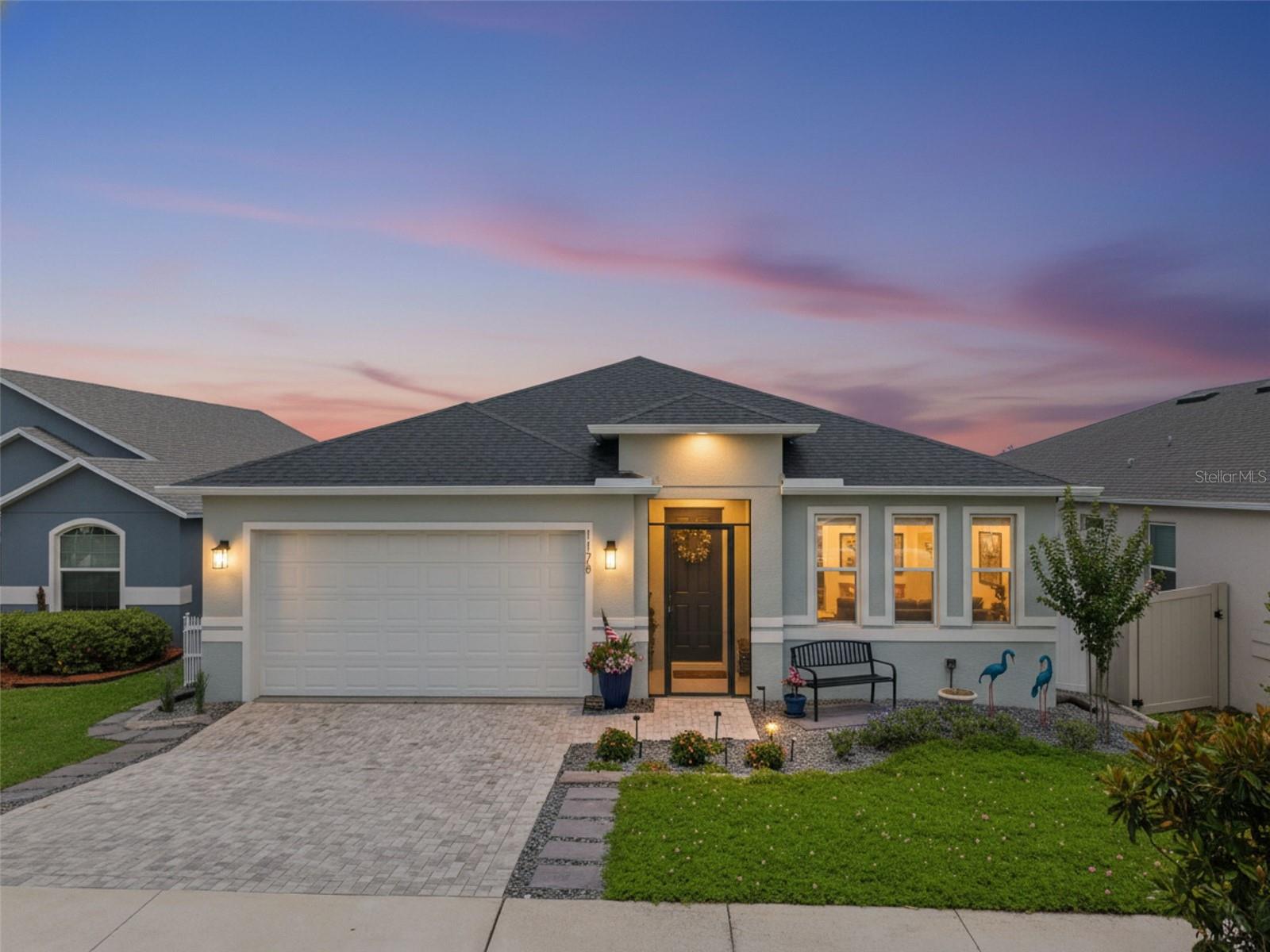 NO CDD FEE & LOW HOA!! Located in the sought after Sunrise Ridge community of Groveland, this custom built 2021 Pillar Homes residence offers a rare opportunity to own a home crafted by one of Central Florida's respected family owned builders, known for personalized construction, quality craftsmanship, energy efficient design, an A+ BBB rating, and recognition among Florida's top builders. Unlike many homes built by large production builders, this 3 bed-2 bath 1812 Sqft home with PAID OFF Solar Panels has Tile & LVP throughout, showcases thoughtful custom details throughout, including 42-inch kitchen cabinets with crown molding, a spacious walk-in pantry, a large island with breakfast bar, plantation shutters, and abundant natural light.The home comes with a water filtration system inclusive of a water softener. The primary suite enjoys beautiful morning sunshine and features an oversized walk-in closet, dual vanities, a walk-in shower and a private water closet. Outdoor living is equally impressive with a screened front entry, a rear screened in  lanai with an extended exterior patio surrounded by a fully fenced vinyl backyard that provides both privacy and space to enjoy Florida's outdoor lifestyle. The landscaped front yard features a magnolia tree, attractive rock beds, and drought tolerant mimosa mowable ground cover that enhances curb appeal while minimizing maintenance in the Florida climate, while the paver driveway adds to the home's polished exterior. Sunrise Ridge is surrounded by Groveland's rolling hills and scenic lakes, offering a peaceful setting with community amenities including a playground and sidewalks, while remaining conveniently close to Lake Louisa State Park, local shopping and dining, highly rated area schools, and the Florida Turnpike for easy access to Orlando. With no CDD fees and a location that balances nature, convenience, and community, this home stands out as a distinctive alternative to the area's more typical cookie cutter construction. Please view the “Virtual tour” link to immerse yourself in the 3D walk-through giving you the elevated experience of virtually walking through the home.