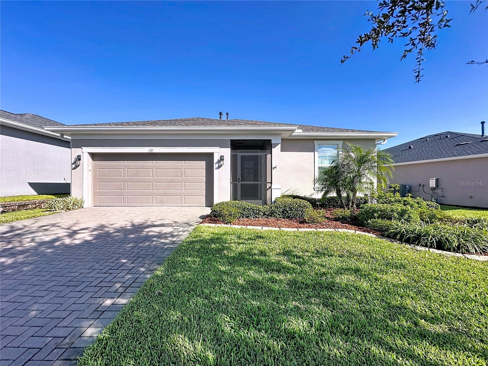 YES!!!  A perfect combination of STYLE, FUNCTION, ENERGY EFFICIENCY, and THOUGHTFUL UPGRADES- this is the home you’ve been waiting for. Be sure to read every detail because this one is truly special!ENERGY-EFFICIENT and BEAUTIFULLY UPGRADED, this exceptional 3-BEDROOM, 2-BATH home with a BONUS ROOM is one you won’t want to miss! Open the stunning 8’ DESIGNER GLASS FRONT DOOR and prepare to be impressed. Step inside to STYLISH TILE-PLANK FLOORING THROUGHOUT and a spacious OPEN-CONCEPT GREAT ROOM that seamlessly connects the kitchen, dining, and living areas, perfect for both everyday living and effortless entertaining.The modern kitchen features a NATURAL GAS RANGE, OVERSIZED GRANITE ISLAND, GE REFRIGERATOR, convenient POT-AND-PAN DRAWERS, and both PENDANT + RECESSED LIGHTING. A SOLAR TUBE floods the space with natural light, enhancing both beauty & energy efficiency. Thoughtful design and complementary finishes make this kitchen as functional as it is stylish. private primary suite is a true sanctuary, filled with natural light and designed to accommodate oversized furniture with ease. It features a DESIGNER CEILING FAN, blinds, and TOP-DOWN / BOTTOM-UP SHADES for enhanced privacy and light control. The primary bath offers sleek finishes, dual vanities, a frameless glass shower, a linen closet, and a private water closet. The spacious CUSTOM-DESIGNED WALK-IN CLOSET features built-in drawers, shelves, and hanging space for exceptional organization.

The oversized laundry room offers excellent functionality with a MAYTAG WASHER & GAS DRYER plus additional shelving for storage. The impressive garage provides more than just parking—it features EXTRA SPACE FOR A WORKSHOP, HOBBY AREA, OR GOLF CART, OVERHEAD STORAGE RACKS, a convenient UTILITY SINK, and a GARAGE for added versatility.

This home is loaded with valuable upgrades designed for comfort, efficiency, and peace of mind, including a TRANSFERABLE TERMITE BOND, SOFT WATER SYSTEM, SOLAR ATTIC FAN, and BLUE LIGHT MOLD PROTECTION SYSTEM.

Step through the sliding glass doors into your personal outdoor oasis. The OVERSIZED SCREENED & COVERED LANAI is designed for ultimate relaxation while enjoying peaceful, sweeping views. The beautifully landscaped yard features IRRIGATION, MATURE LANDSCAPING, and DECORATIVE CONCRETE EDGING, creating a serene outdoor retreat perfect for relaxing or entertaining.This guard-gated, resort-style community offers more than just home, it delivers a lifestyle! The HOA covers cable, high-speed internet, security monitoring, and landscaping/ lawn care so you can focus on enjoying your time. At the heart of it all is the spectacular 57,000 sq ft Magnolia House, where you’ll enjoy Member-exclusive restaurant and bar with live entertainment. Indoor/outdoor heated pools & a state-of-the-art athletic club Artisan studio, poker room, culinary kitchen, and creative spaces. Sports courts for tennis, pickleball, bocce, billiards & virtual golf,50+ active, member-led clubs for every hobby and interest. A show-stopping Event Center with a stage and professional AV setup. This isn’t just a home, it’s a lifestyle upgrade where you’ll find connection, wellness, excitement, and belonging every day. Conveniently located 45 minutes to Theme Parks including Universal and Disney World and Orlando International Airport, 1 ½ hour to Beaches and Port Canaveral Cruise Terminal. This isn’t just a home — it’s a lifestyle upgrade. Live your BEST LIFE at Trilogy!