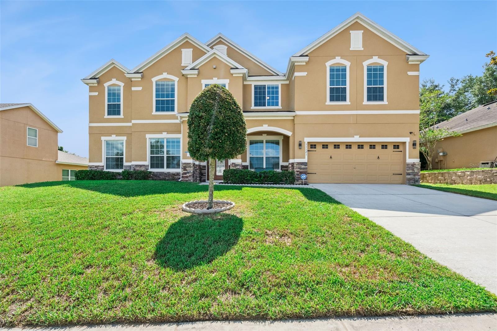 Affordable luxury, exceptional space, and true pride of ownership come together in this meticulously maintained Clermont home. Built by Meritage Homes and cared for by its original owners, this impressive Del Rio model offers 7 bedrooms, a first-floor primary suite, and two additional ground-floor flex rooms, ideal for working from home, homeschooling, a den, or extra living space.

Major recent updates include a brand-new roof with Atlas 30-year shingles and two new water heaters, all completed in June 2026. The home also features two AC units for comfort and efficiency, with one recently replaced. From the decorative glass front doors to the bright foyer, diagonally laid tile, granite counters, 42-inch cabinetry, stainless steel appliances, breakfast bar, and open family room with pool views, every detail reflects care and quality.

The first-floor primary suite offers a spacious retreat with walk-in closet, garden tub, granite counters, and well-designed bath. A pool bath with shower adds everyday function. Upstairs, the large bonus room features a custom bar with refrigerator, granite counter, authentic bar taps, and neon lighting, creating an incredible space for entertaining.

Movie lovers will appreciate the custom theater room with staged cinema seating, custom cabinetry, 115-inch perforated screen, Bose speaker system, subwoofer, amplifier, and gaming/DVD connectivity. Additional technology includes a hardwired 4-camera security system, intercom/radio system, and built-in Sonos wired speaker system with prewiring for display panels and ceiling speakers.

Outside, enjoy a 12x24 custom screened pool by Holland Pools, a covered lanai, and excellent entertaining space. The pool has existing pipework and a thermostat for solar heating, and the home’s southern exposure offers future solar potential. Located in Overlook at Lake Louisa, close to shopping, dining, schools, major roads, Lake Louisa State Park, the Chain of Lakes, trails, parks, boating, and kayaking.