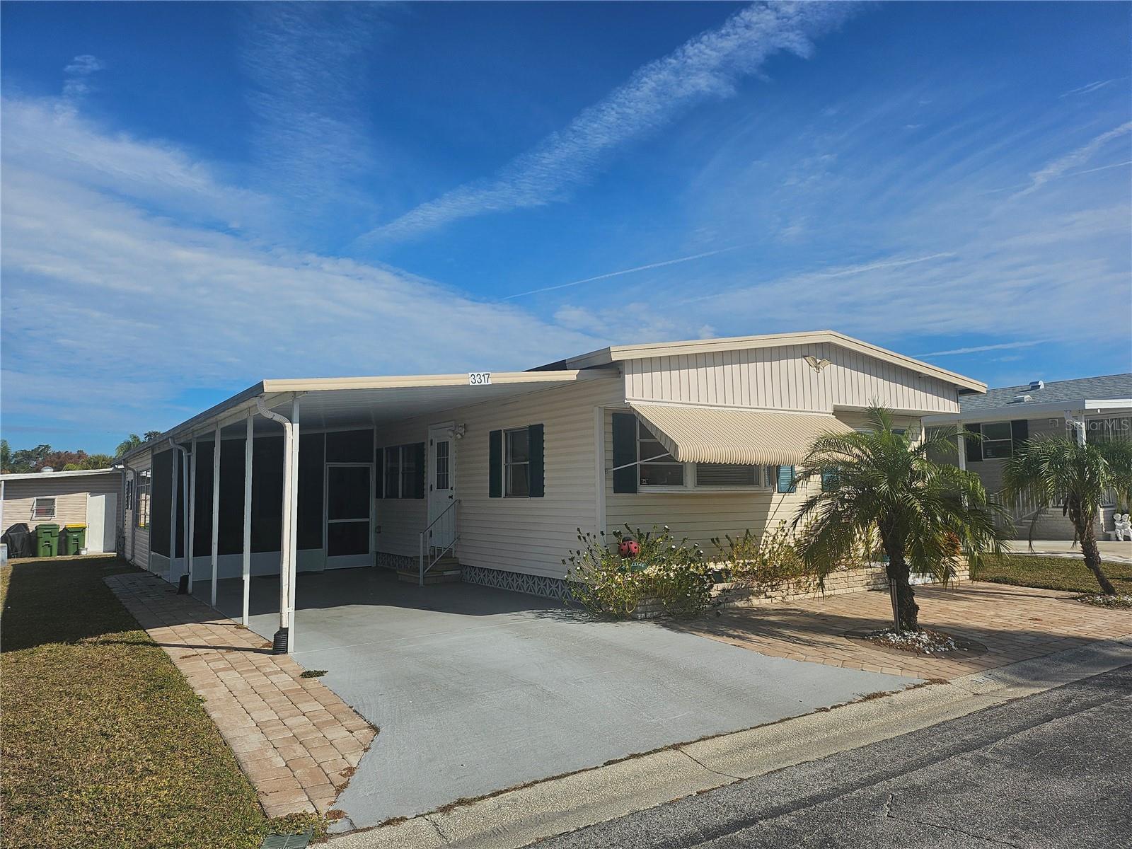 A Great Deal!!

Discover the ease and comfort of Florida living in this thoughtfully maintained TURNKEY furnished home located in the ONLY gated 55+ Resident Owned Park in the City limits of Sarasota!! This 3 bedroom home has beautiful curb appeal with the landscaped pavers and palm trees. This home has been tastefully decorated and offers a peaceful, move-in-ready retreat— ideal for seasonal or full time residents seeking sunshine, simplicity, and comfort.

Guest will appreciate the split plan feature with the 3rd bedroom conversion. Enter through the quaint French doors to a cottage style queen set, separate AC system, flat screen TV, and private wardrobe.

There is plenty of space for up to 9 with a king bed, queen bed, double bed and both the sofa and loveseat convert into a queen-size sleeper with a new mattress and a single sleeper loveseat, making this ideal for visiting guests. 

The dining table stores extra leaves and there is seating for 6. The coffee table rises to accommodate additional table space.

The kitchen has great natural lighting and includes stainless steel appliances installed in 2020. The dishwasher, rolling island, CD radio player and water filter system were installed after 2021. The pantry provides plenty of room for storage needs.
 
Embrace the relaxed Florida lifestyle with a good book or visit with friends in the screened lanai. Whether you are arriving for the season or enjoying full-time living, immediately begin soaking in Florida’s warm weather, friendly community, and relaxed pace of life.

Upgrades include: Vinyl siding, extra large storage room that can be used as a Florida room as well, separate shed room, washer/dryer and utility sink in the storage area, screen lanai added 2024, HVAC system installed 2020 maintained and enhanced by a whole-house duct enlargement for improved airflow throughout the home. Water heater 2025, vapor barrier replaced 2023, Interior upgrades include the stainless steel appliances, some drywall, updated entry door,  and all flooring has been updated. Additionally, there is a 
hurricane shutter and rain gutters. 

The utility room adds exceptional value, featuring an additional refrigerator, a washer and dryer, offering convenience and extra storage, perfect for seasonal living or hosting guests. 

Note: a few pictured items do not convey with sale.

About Oakwood....This 55+ gated 90 acre community boasts a low maintenance fee of $210/month. Its vast amenities start with the spacious Clubhouse outfitted with a full commercial cook kitchen, event stage, audio/visual, dance floor, state of the art fitness room, activities hall, library with books/movies/puzzles and a pool table. Outside recreation includes an extra large heated pool with a handicap ramp, a spacious kidney shaped hot tub, ample umbrella tables, lounge chairs and updated shower rooms. Oak trees shade the beautiful park area, picnic tables and a community grill. Additional amenities to enjoy are the community putt putt course, bocce ball, ping pong and corn hole. Oakwood Manor is a vibrant community with numerous social events and activities. It is conveniently located adjacent to Legacy Trail and 12 newer pickle ball courts. Just a short drive to our crystal sand beaches, downtown area, the marina, fishing pier, local golf courses, shopping, variety of restaurants, the museum, SRQ airport, SMH and Doctors hospital. Please note that Oakwood is a no pet, no motorcycle Park.
